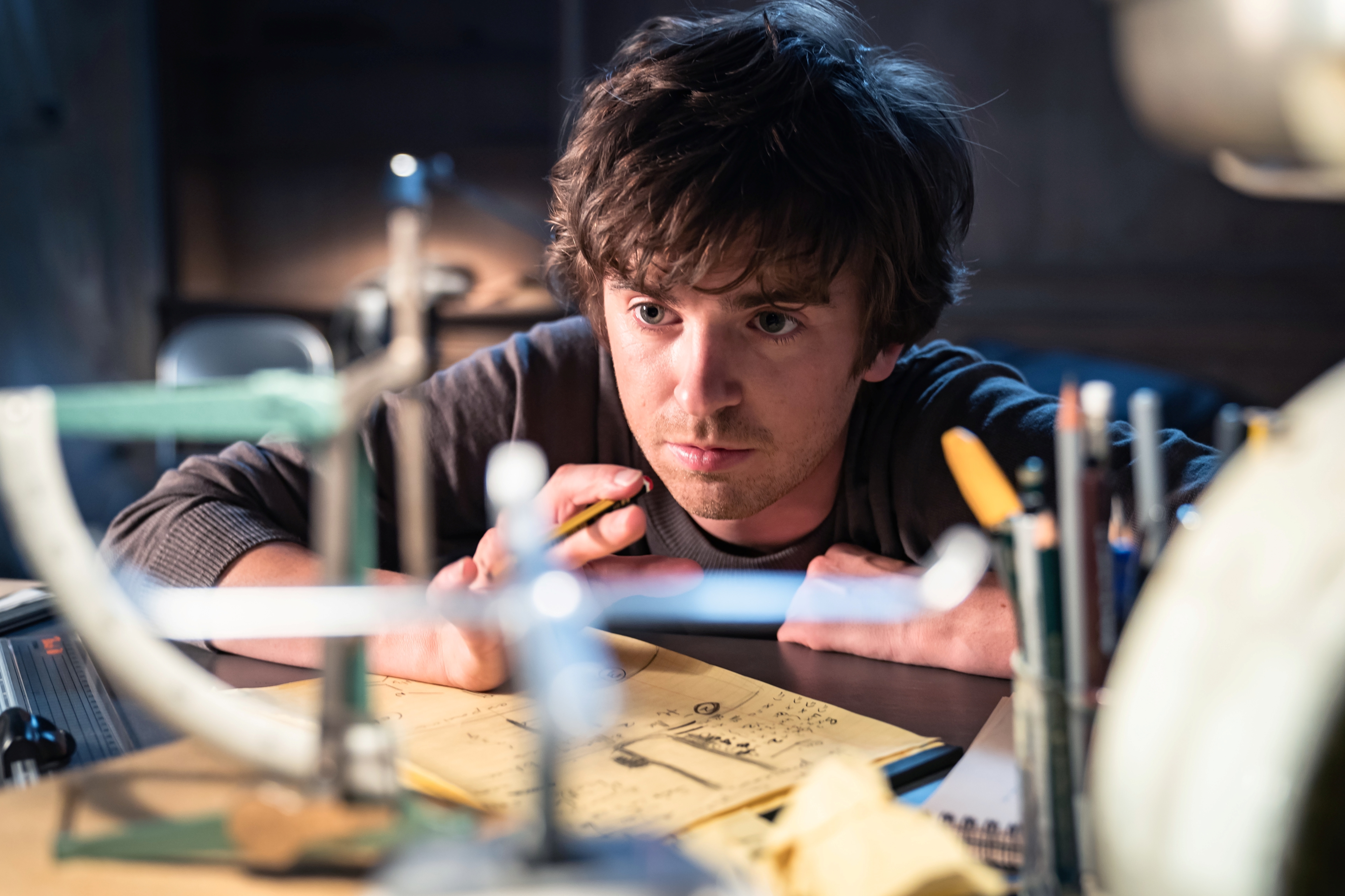 Freddie Highmore studying designs for The Vault HD Wallpaper
