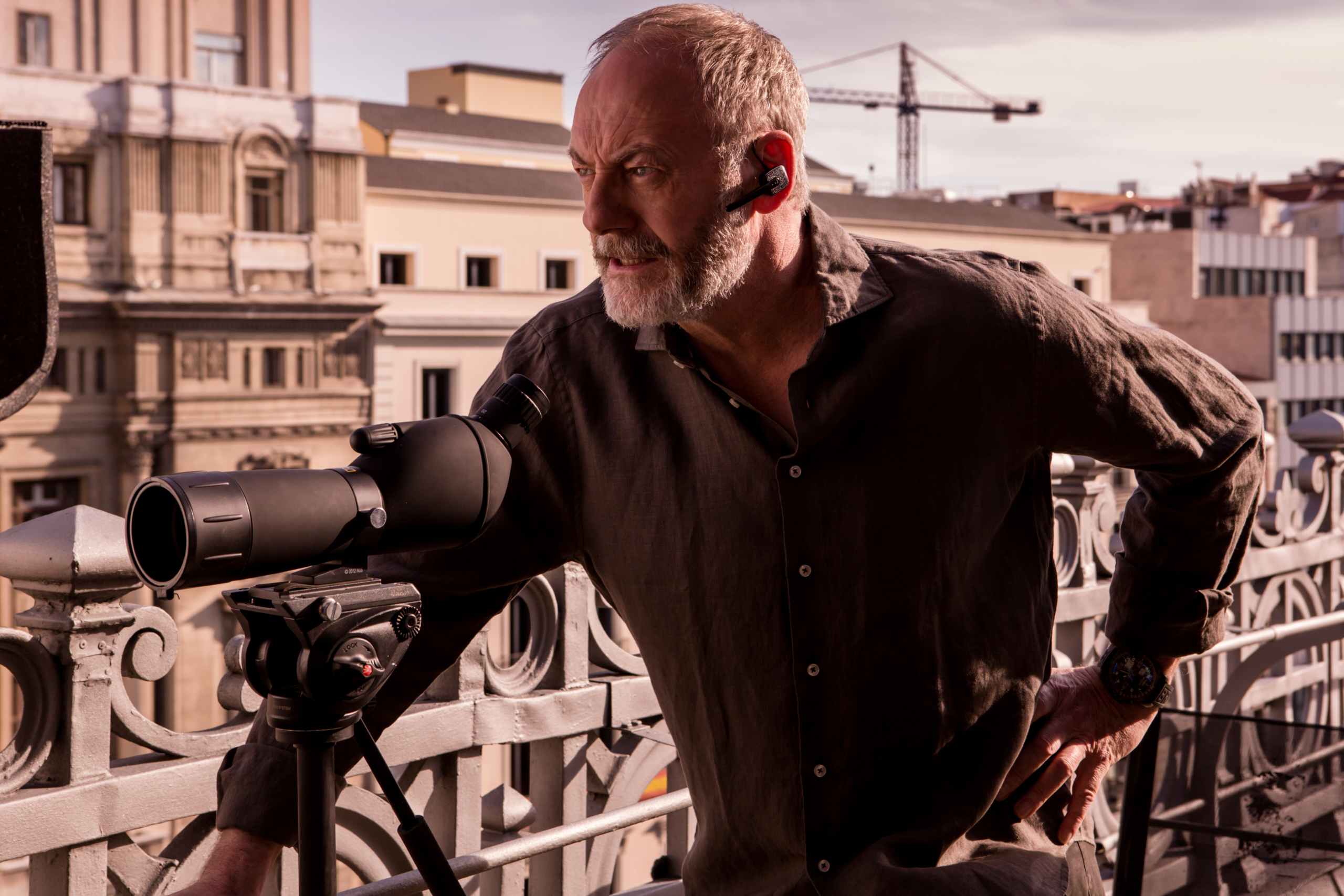 Liam Cunningham observing with a spotting scope in The Vault HD Wallpaper