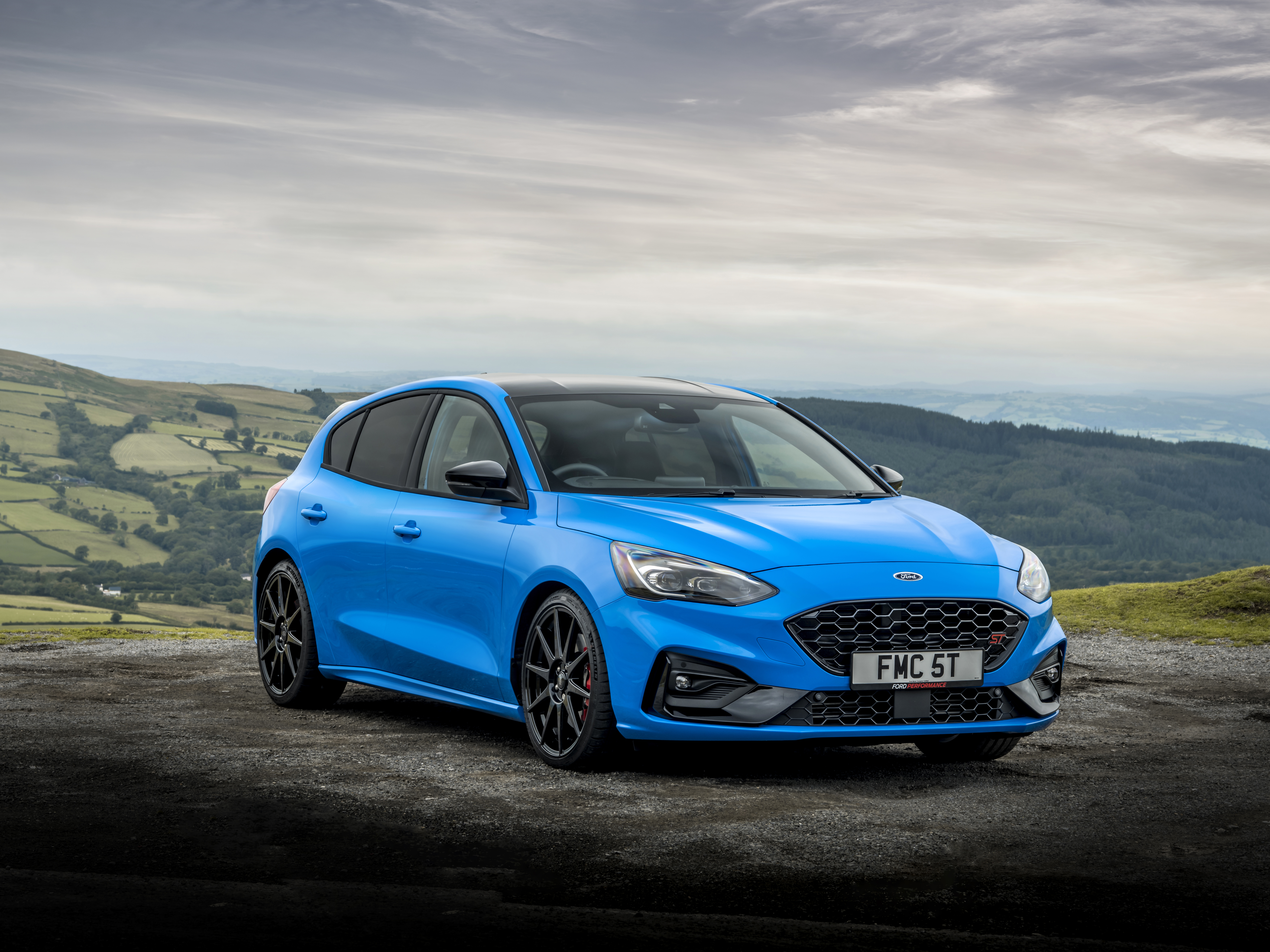 Blue Ford Focus ST on a scenic mountain road HD Wallpaper