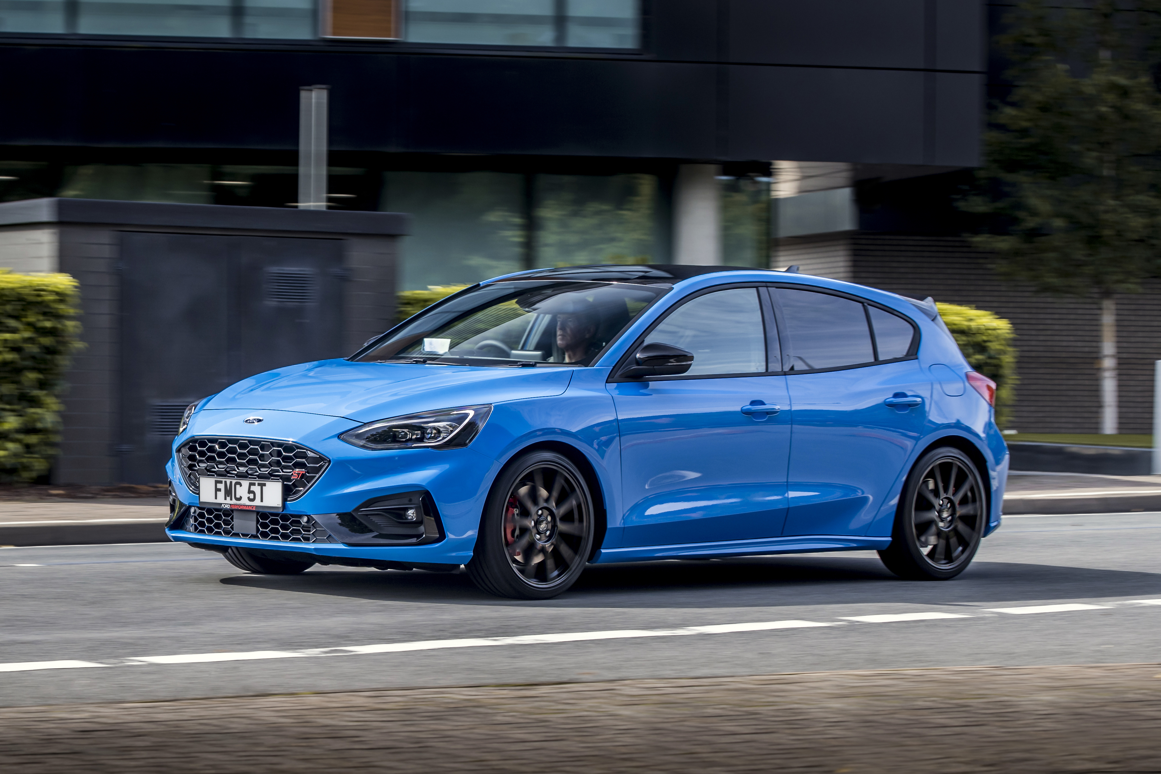 Blue Ford Focus ST driving on a road HD Wallpaper