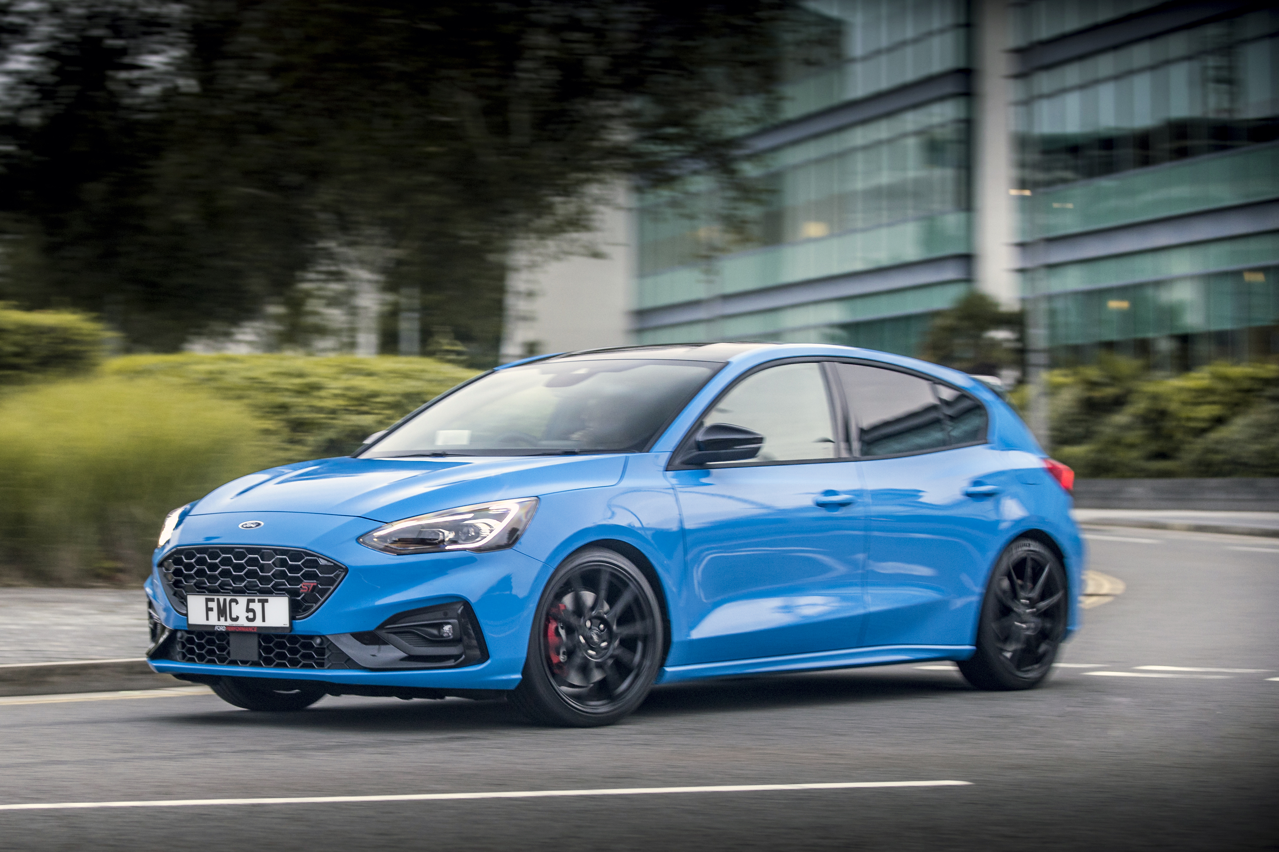 Blue Ford Focus ST driving on a road HD Wallpaper
