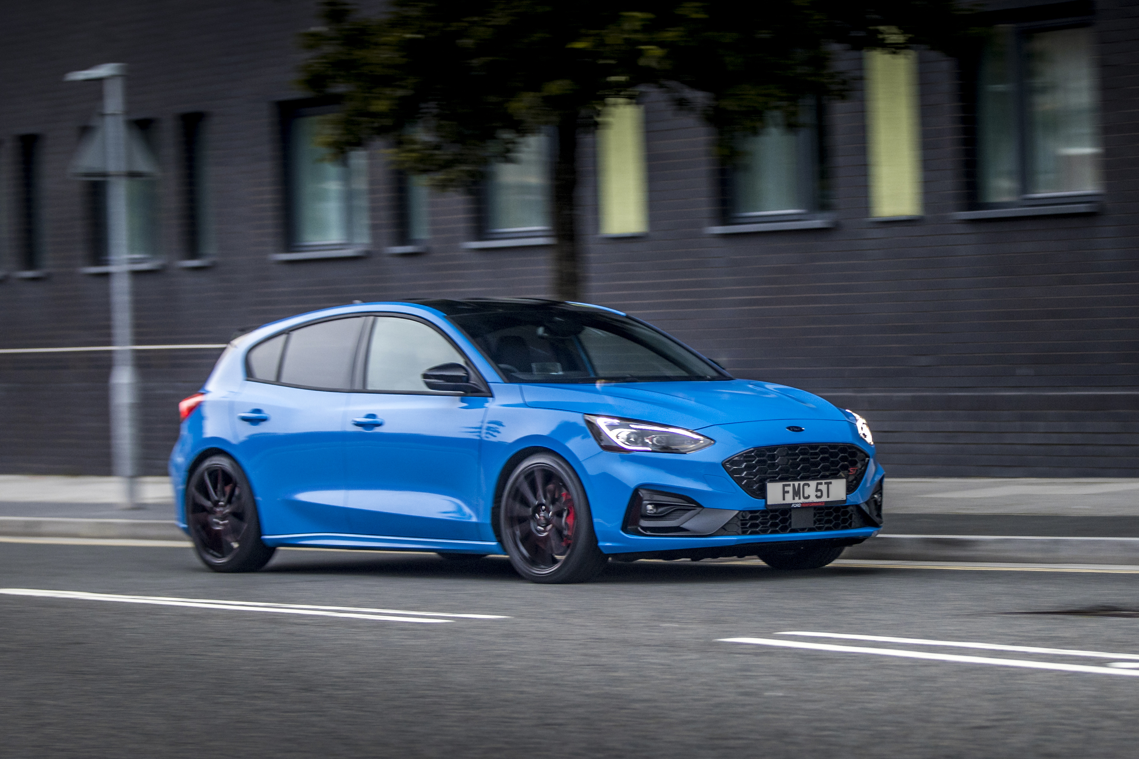 Blue Ford Focus ST driving on a city street HD Wallpaper