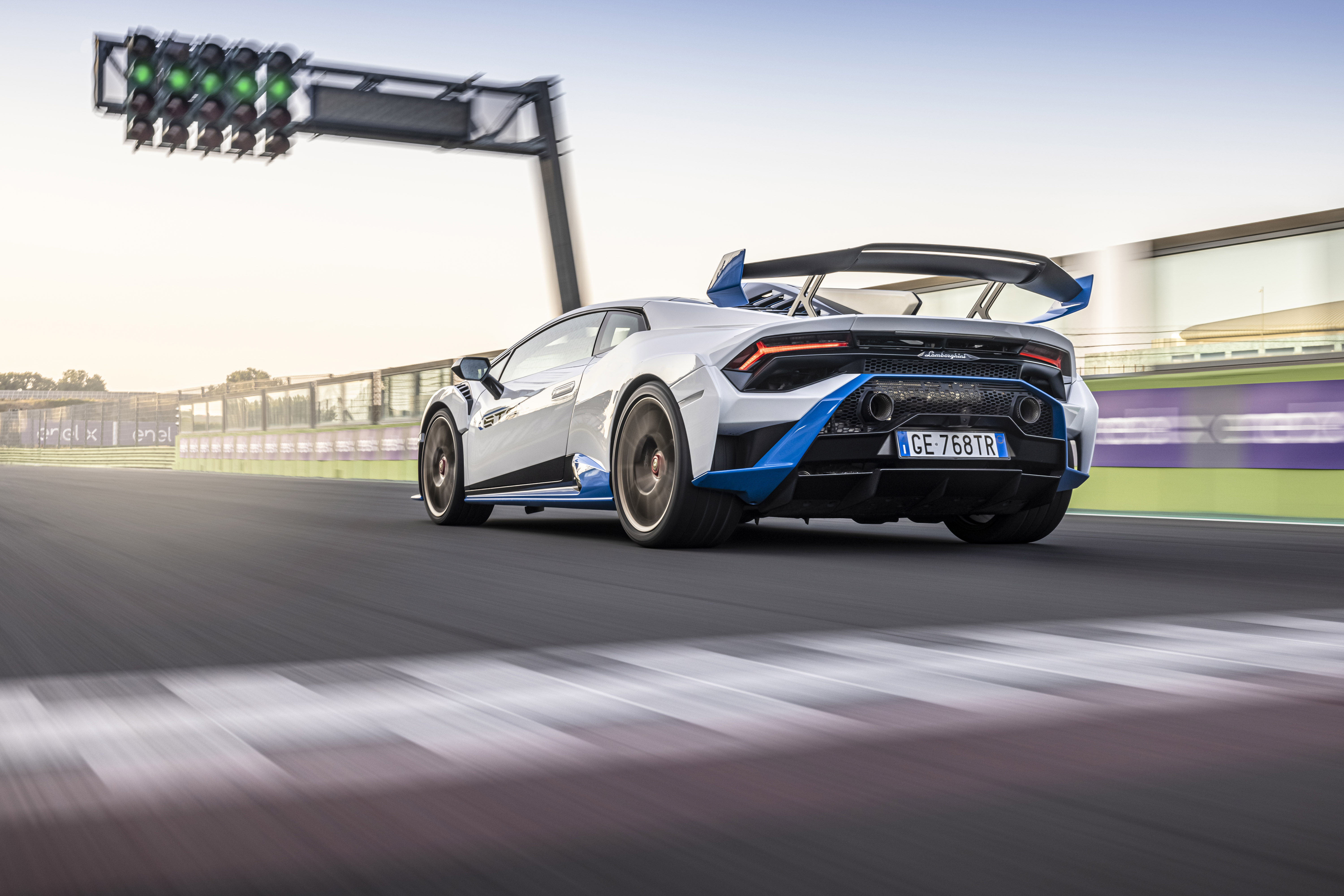 Lamborghini Huracán STO supercar accelerating past green lights HD Wallpaper