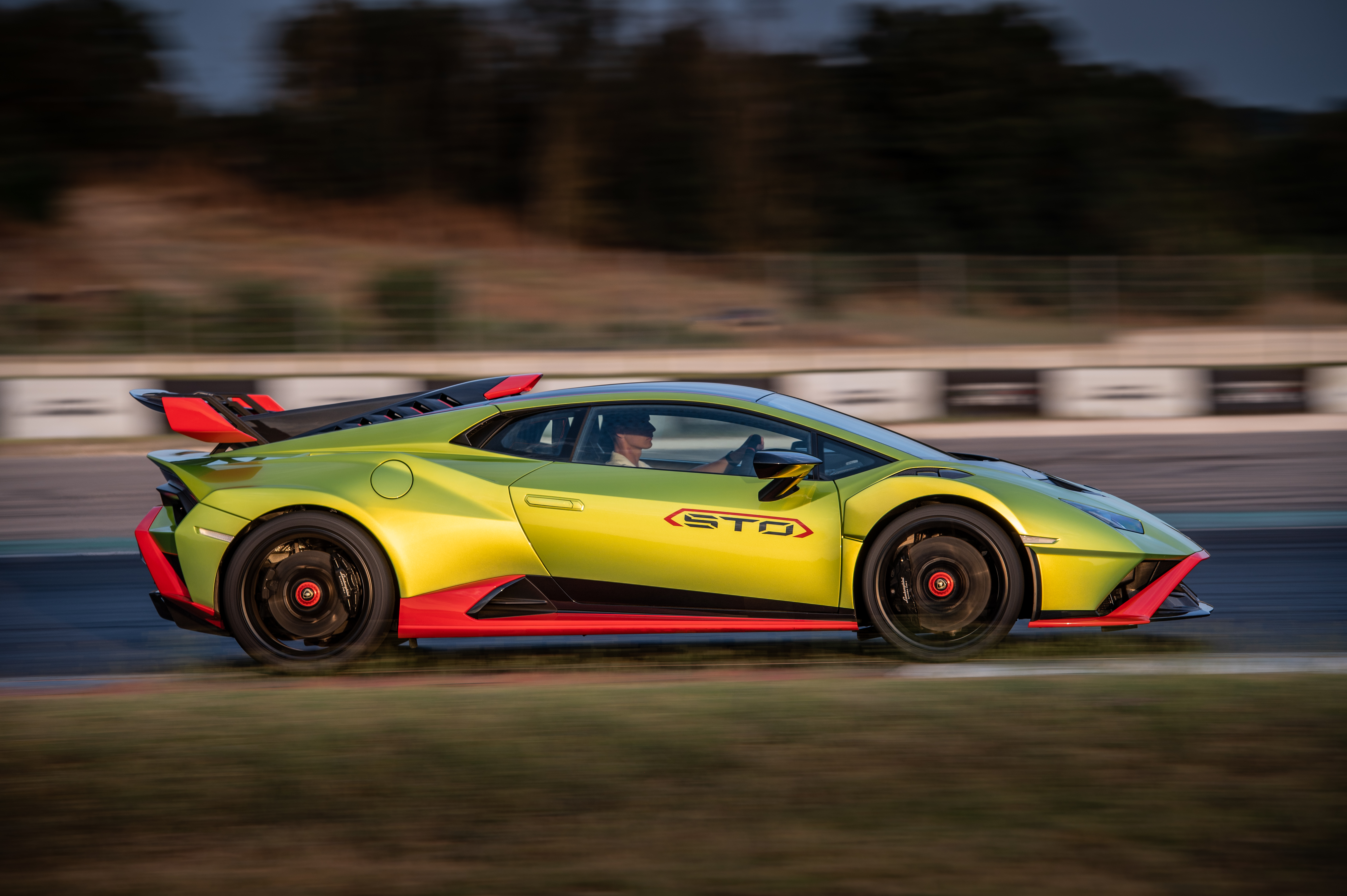Green Lamborghini Huracán STO supercar speeding on track HD Wallpaper