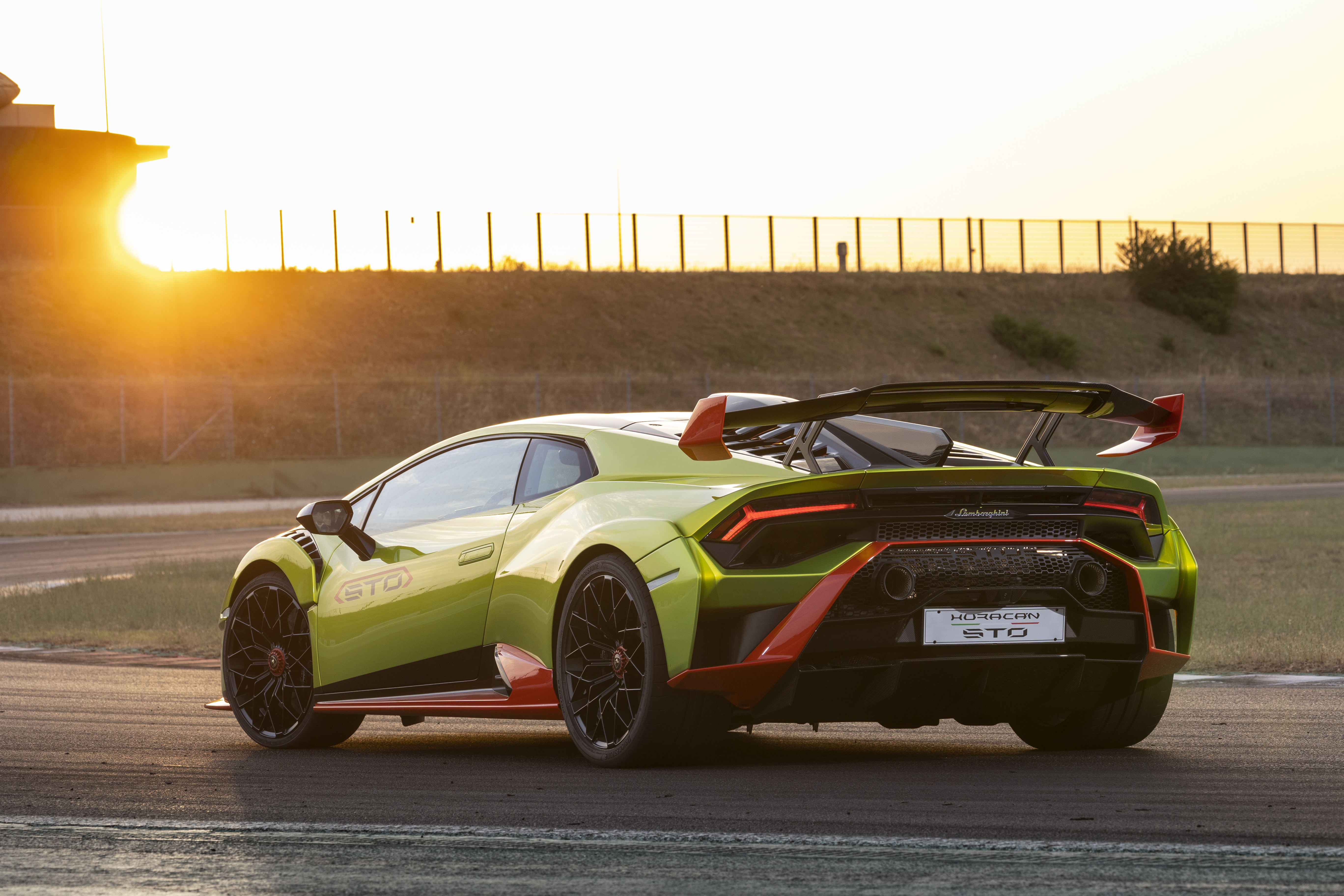 Green Lamborghini Huracán STO supercar at sunset HD Wallpaper