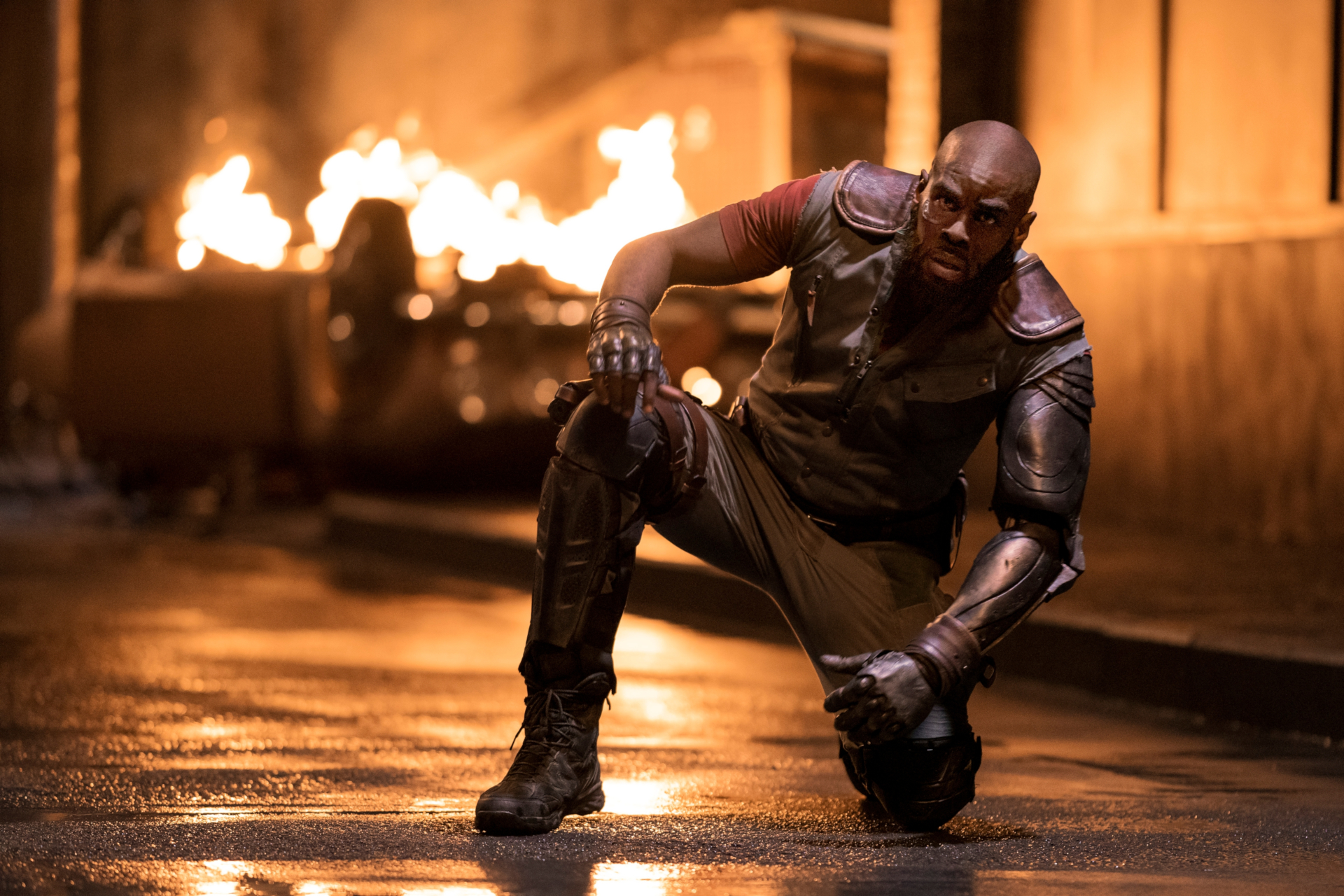 Mustafa Shakir as Jet Black kneeling amidst fire HD Wallpaper