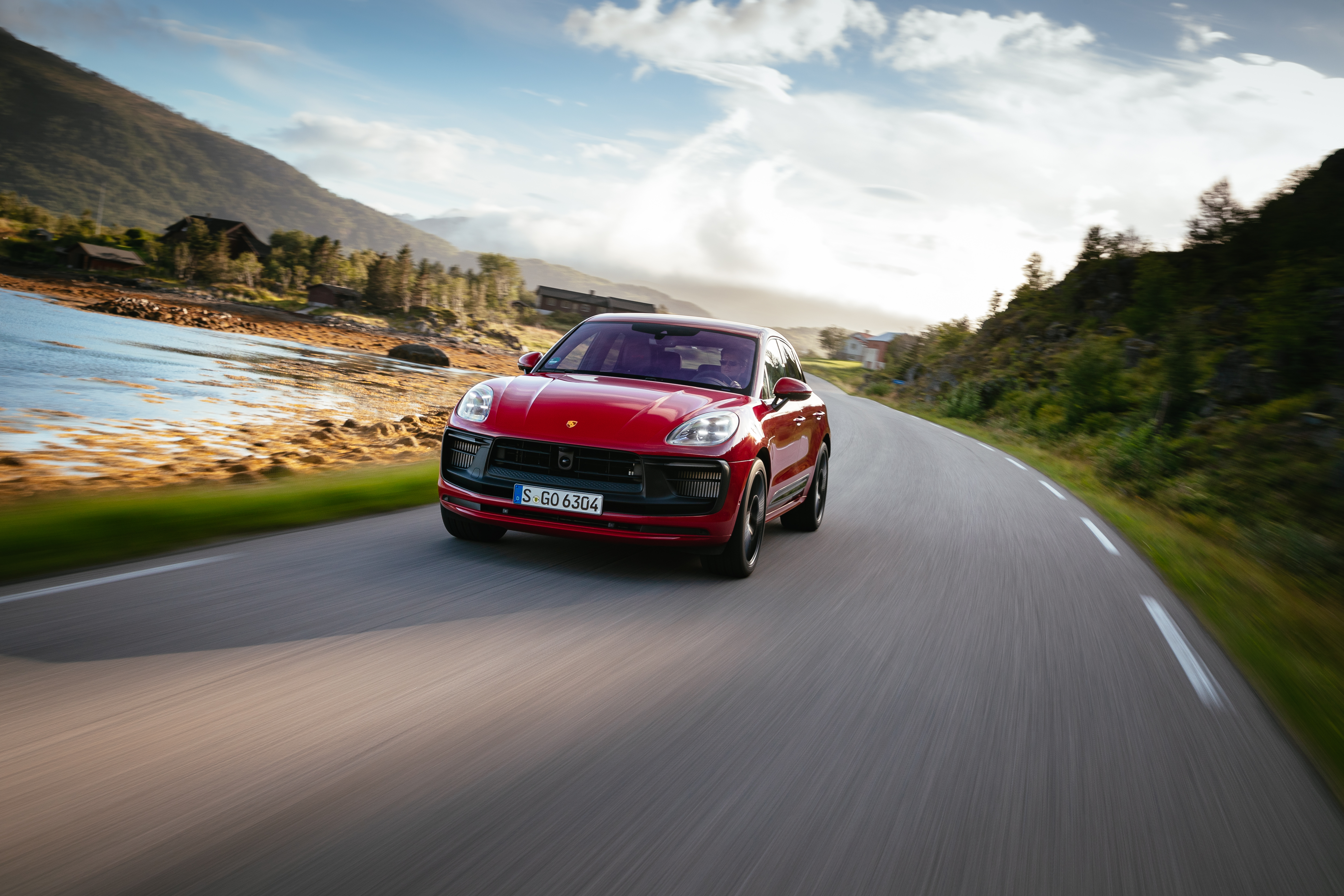 Luxury Red Porsche Macan GTS SUV on a Scenic Road HD Wallpaper