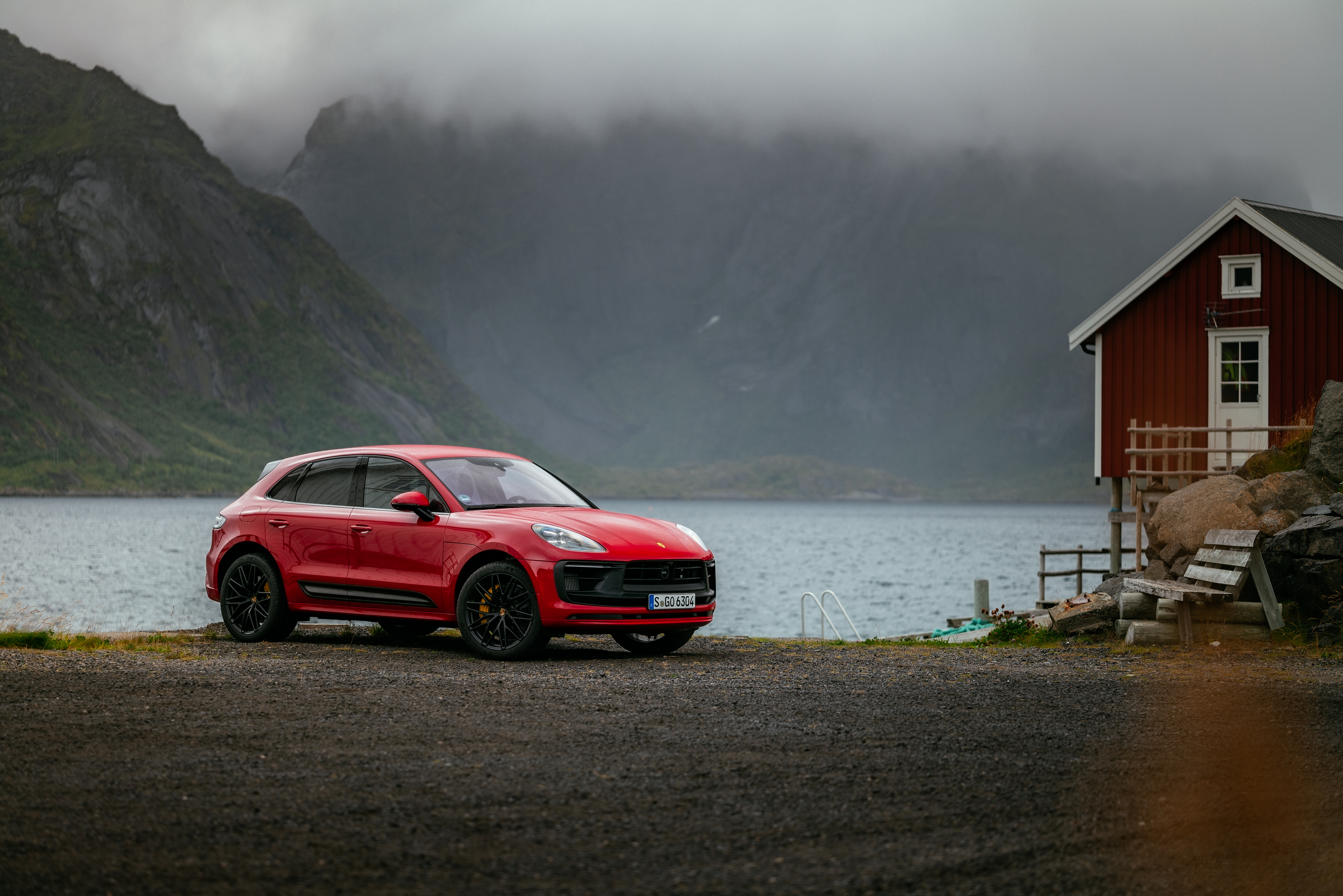 Red Porsche Macan GTS SUV in a misty mountain landscape HD Wallpaper