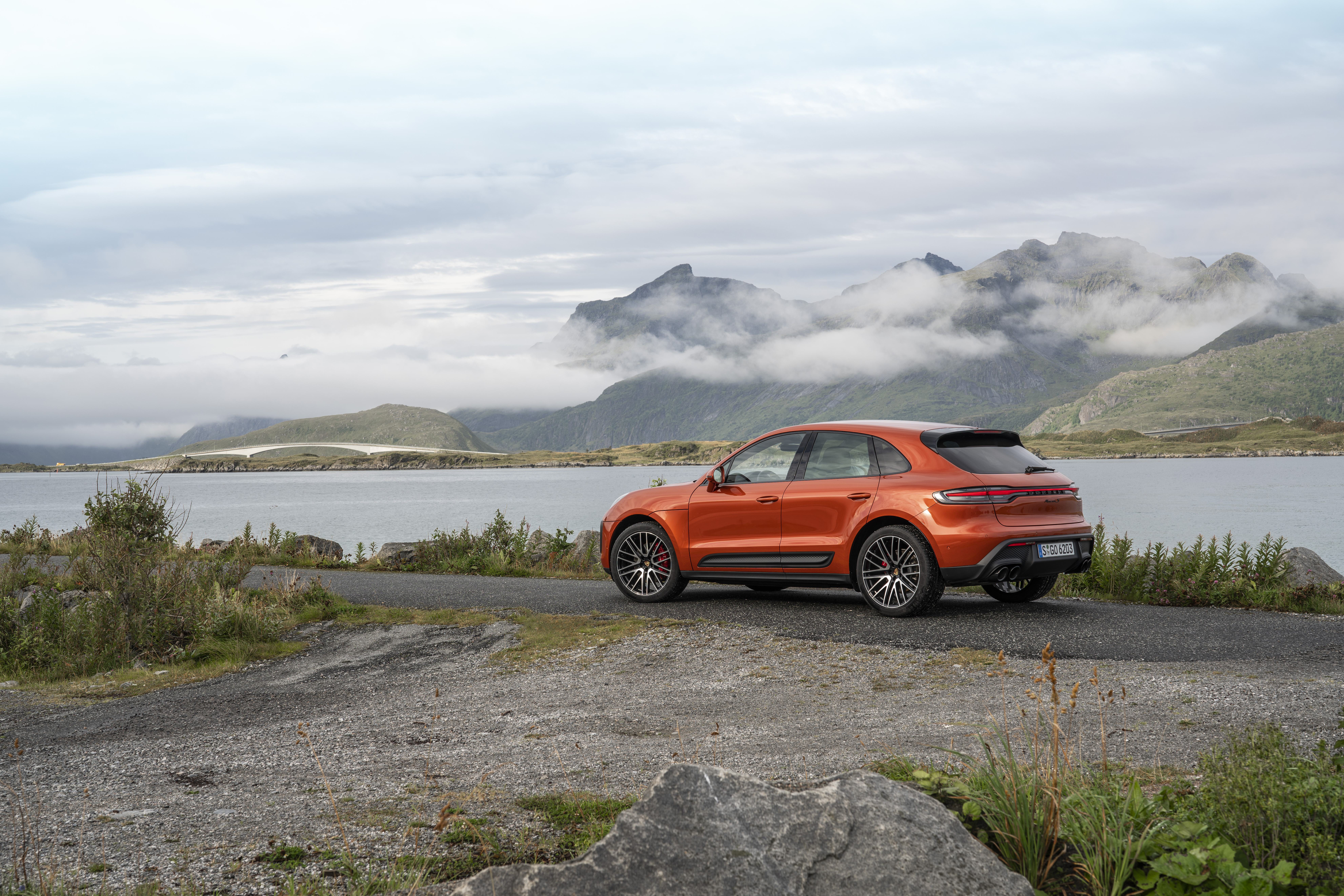 Orange Porsche Macan S SUV in mountain landscape HD Wallpaper