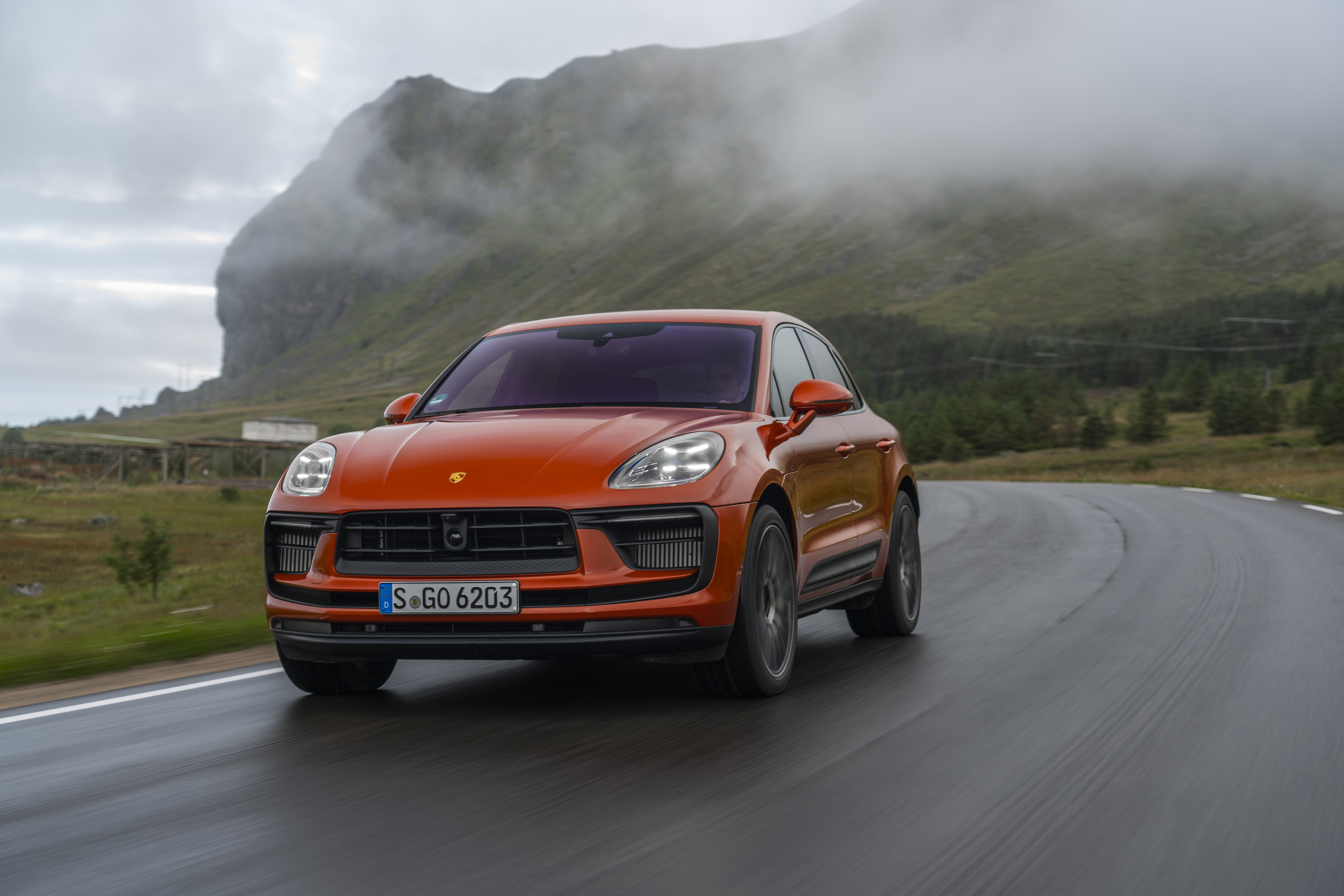 Orange Porsche Macan S SUV on a winding road HD Wallpaper