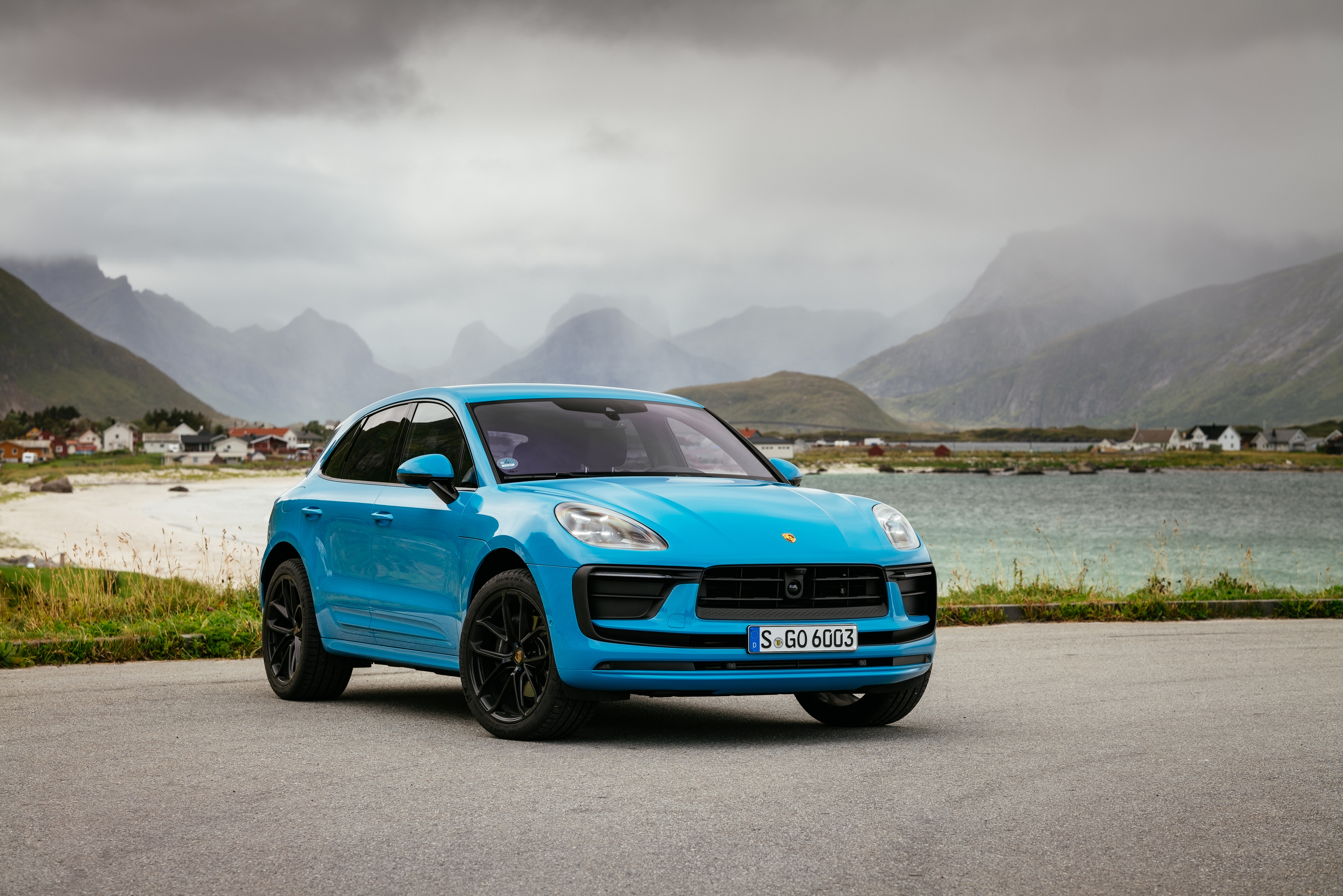 Blue Porsche Macan SUV in a misty mountain landscape HD Wallpaper