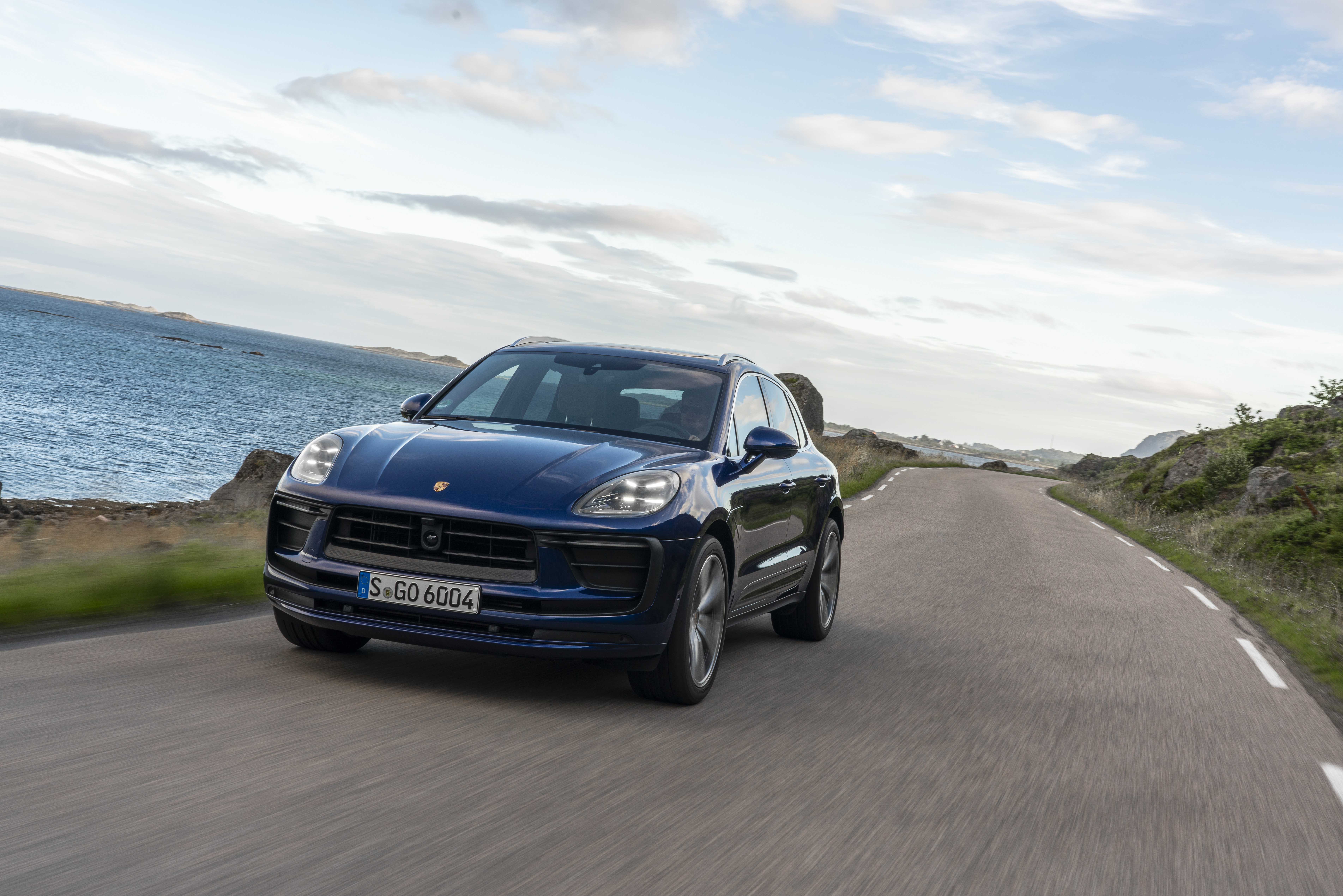Luxury Blue Porsche Macan SUV on a coastal road HD Wallpaper