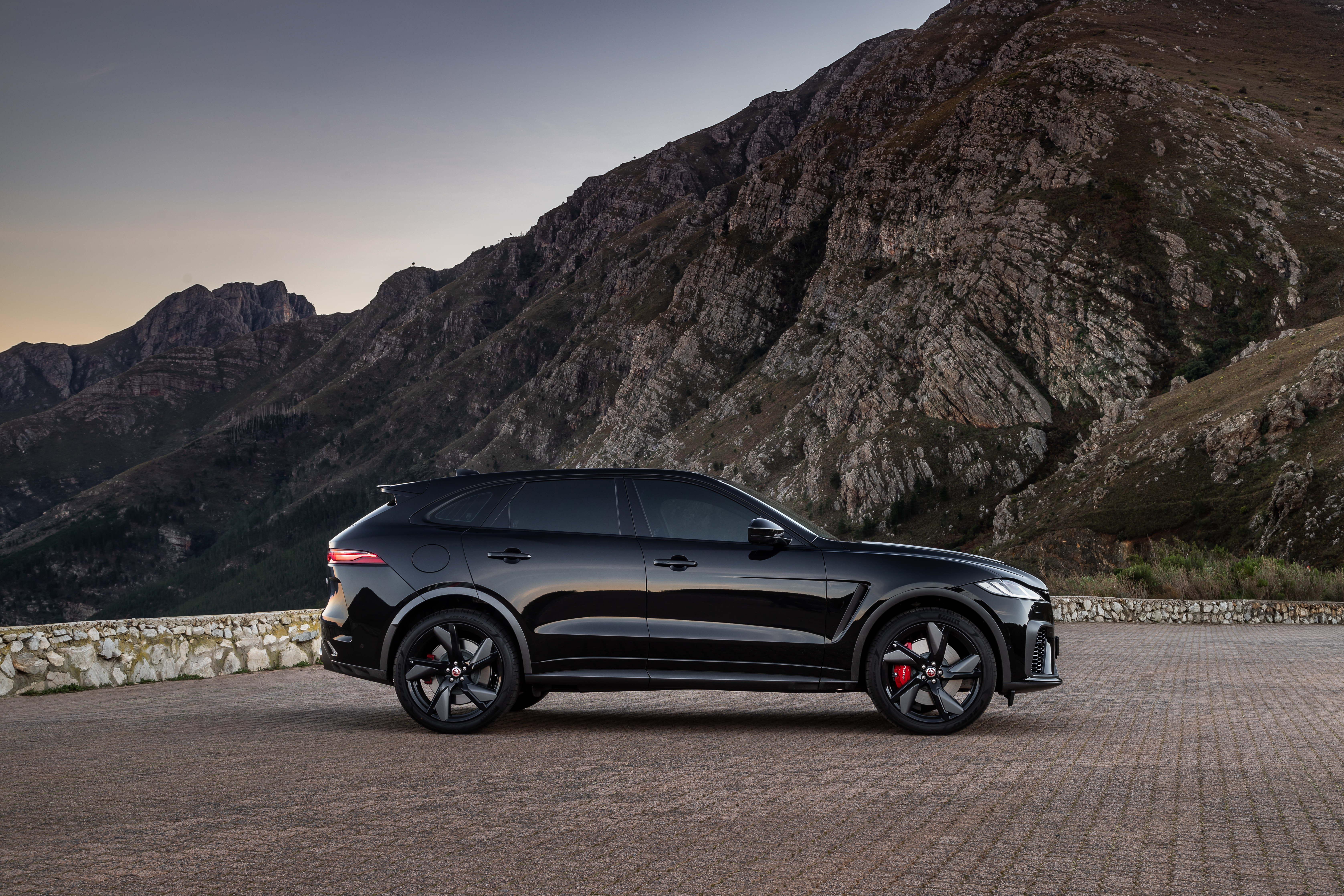Black Jaguar F-Pace SVR SUV in mountains at dusk HD Wallpaper