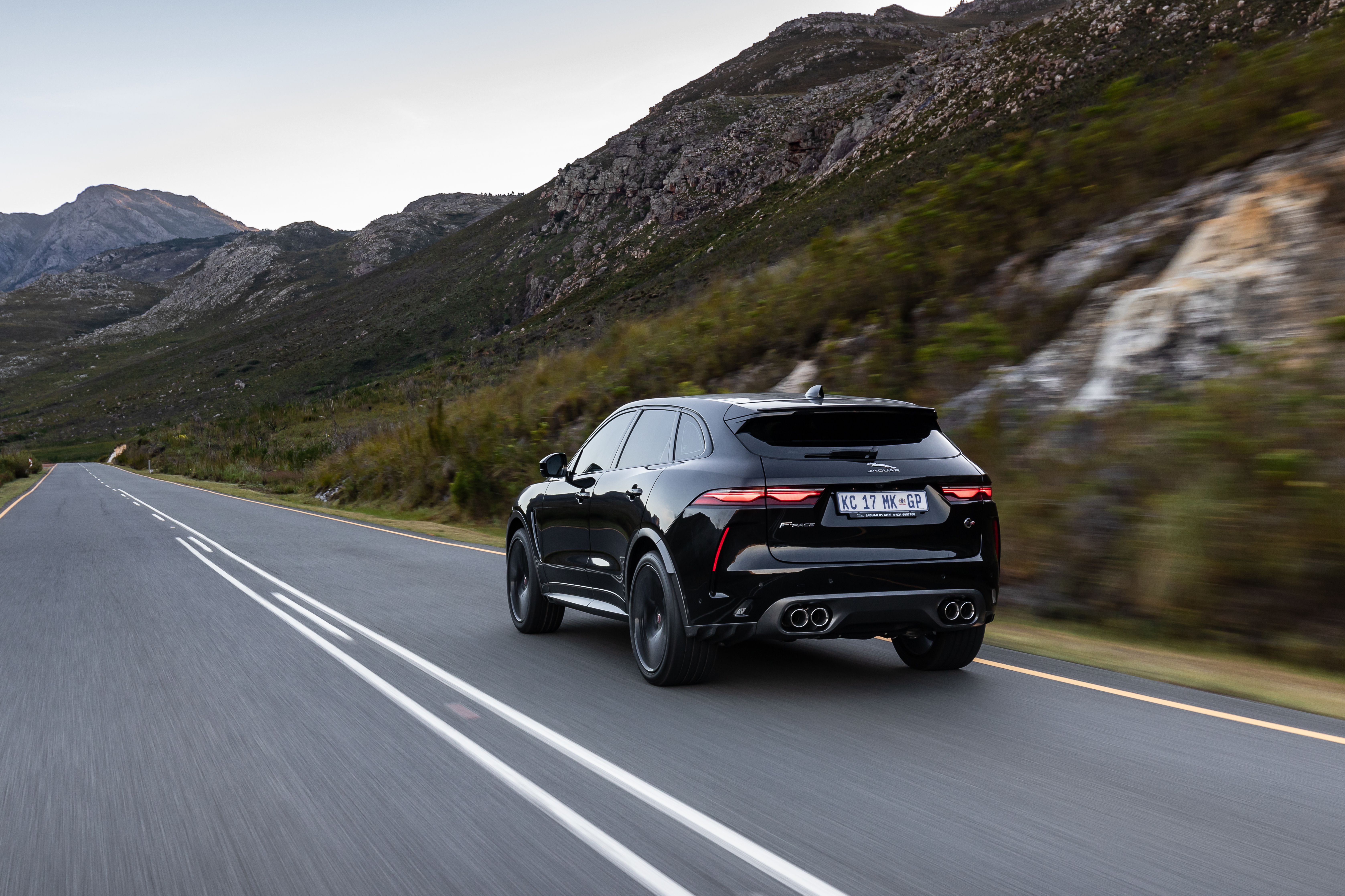 Black Jaguar F-Pace SVR SUV driving on mountain road HD Wallpaper