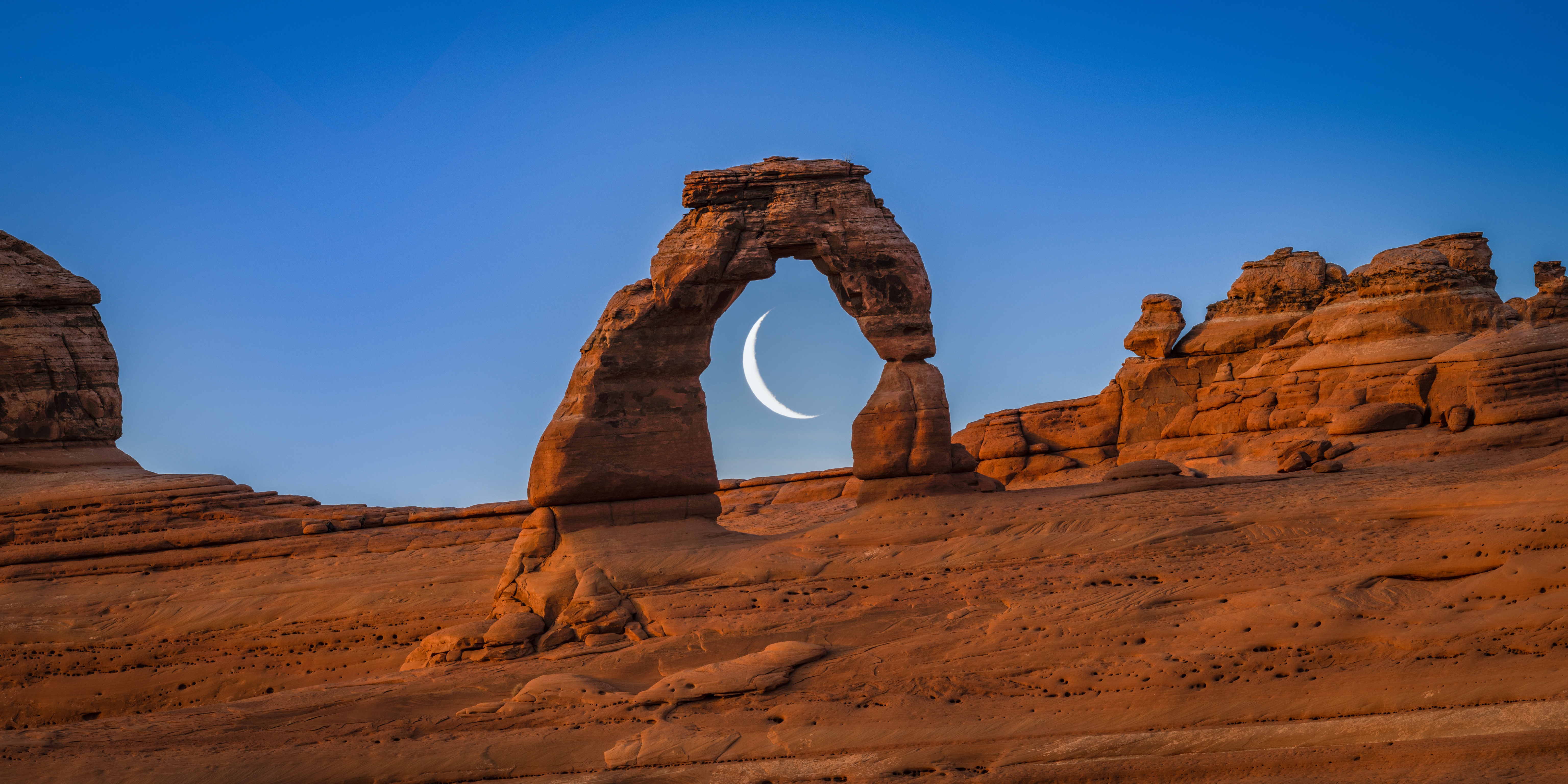 Crescent Moon through Natural Arch at Twilight HD Wallpaper