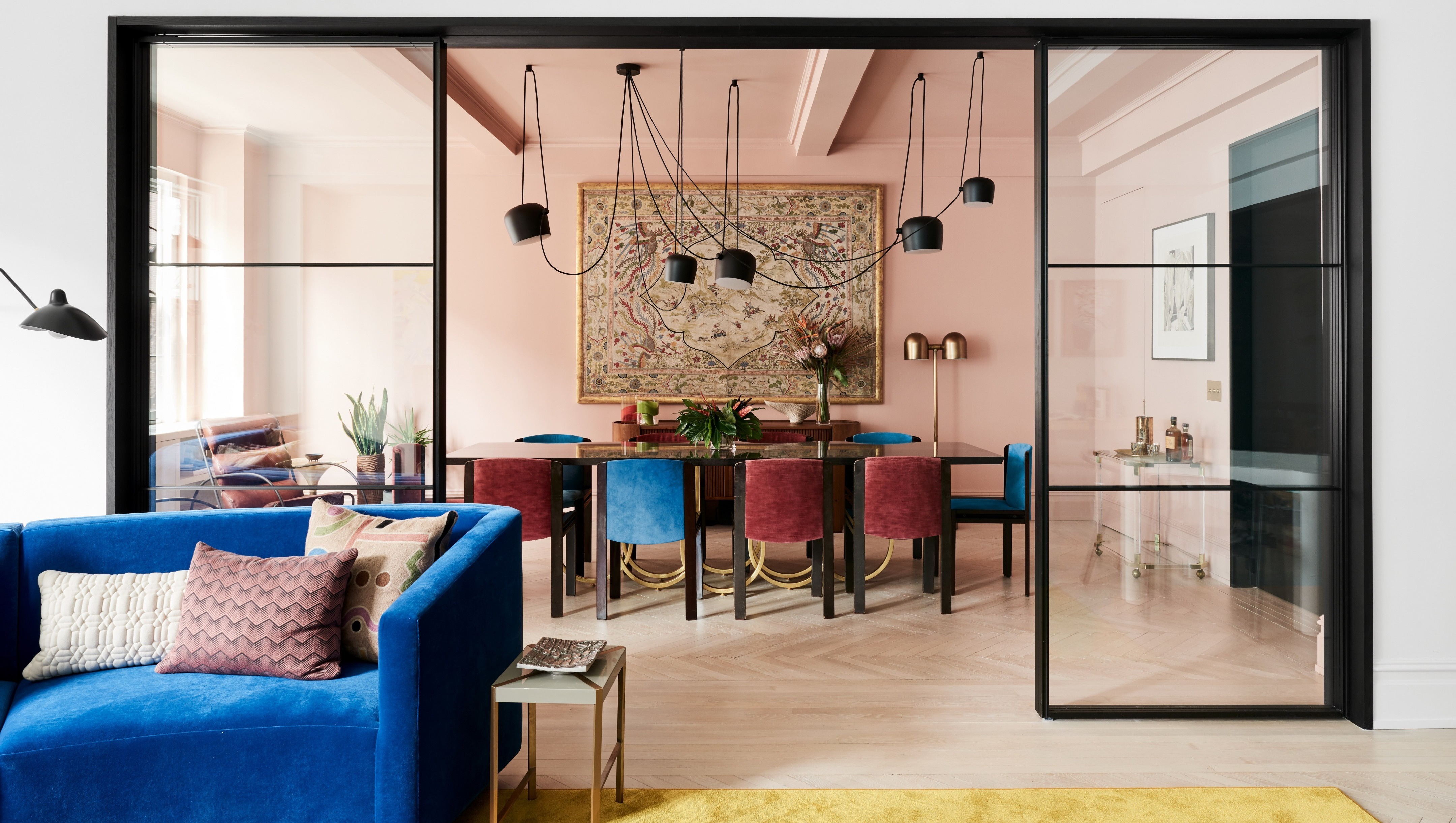 Vibrant Living and Dining Room with Glass Partition HD Wallpaper