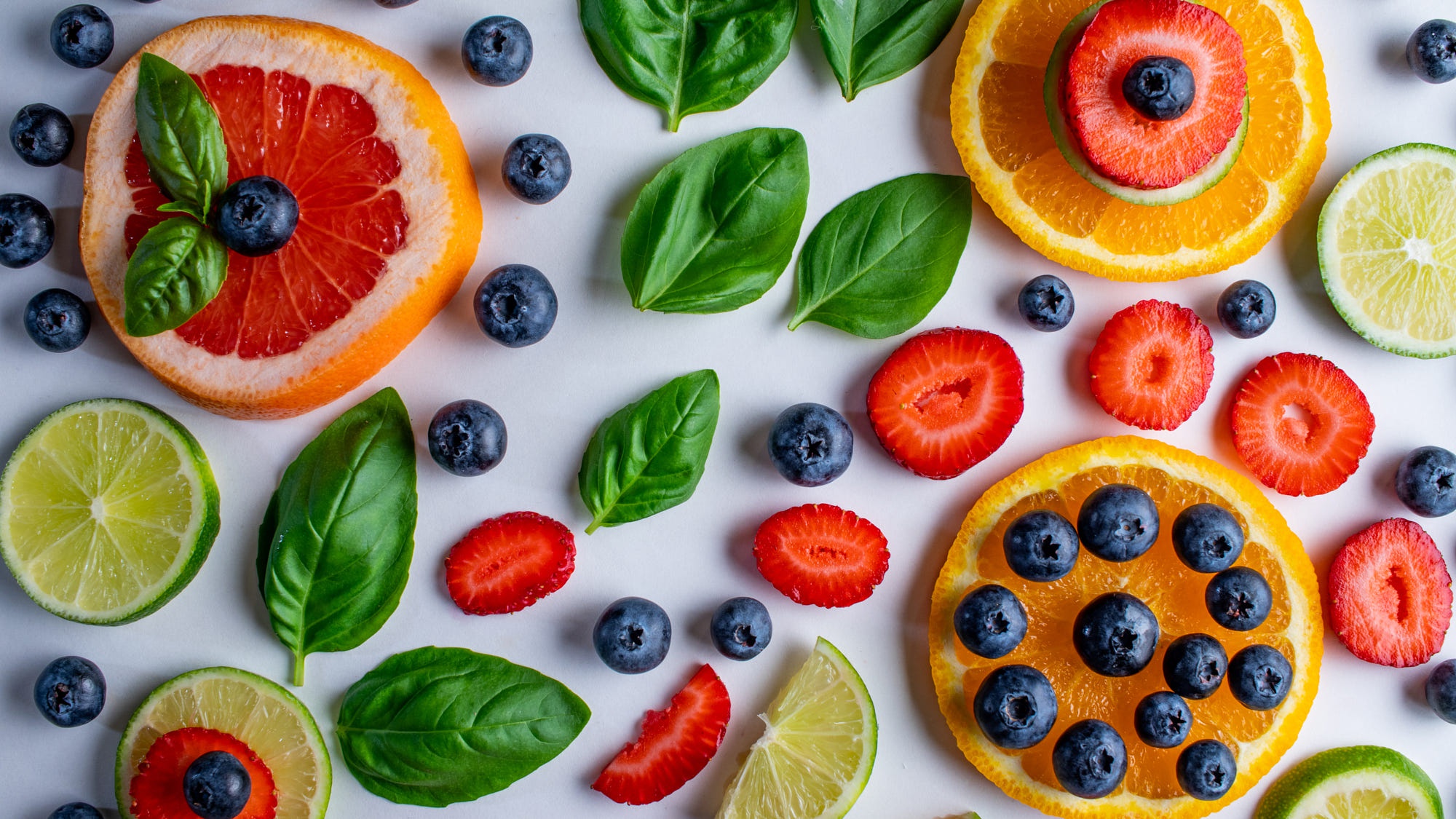 Colorful Citrus, Berries, and Basil Leaves HD Wallpaper