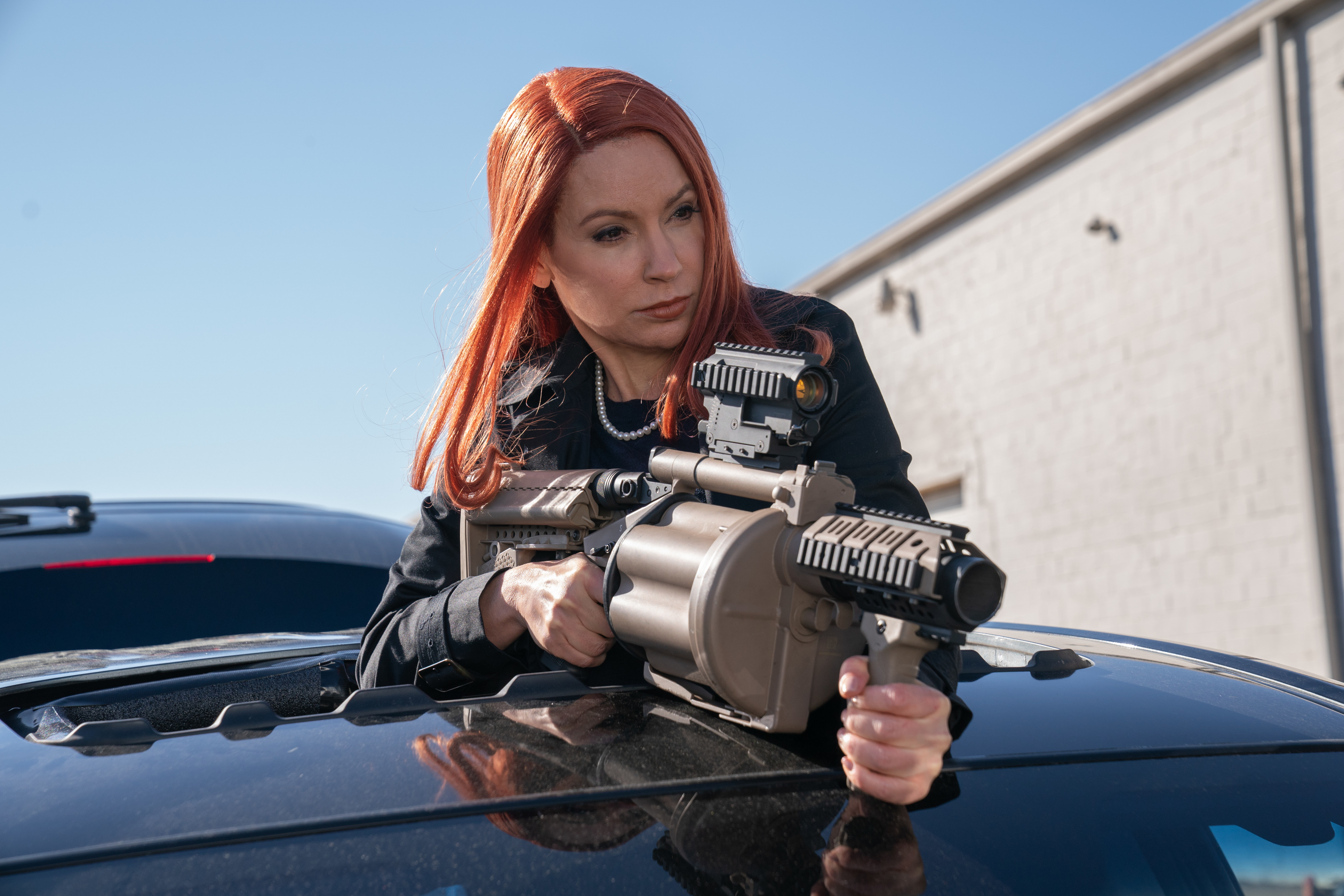 Meadow Williams aiming a weapon from a car in Boss Level HD Wallpaper