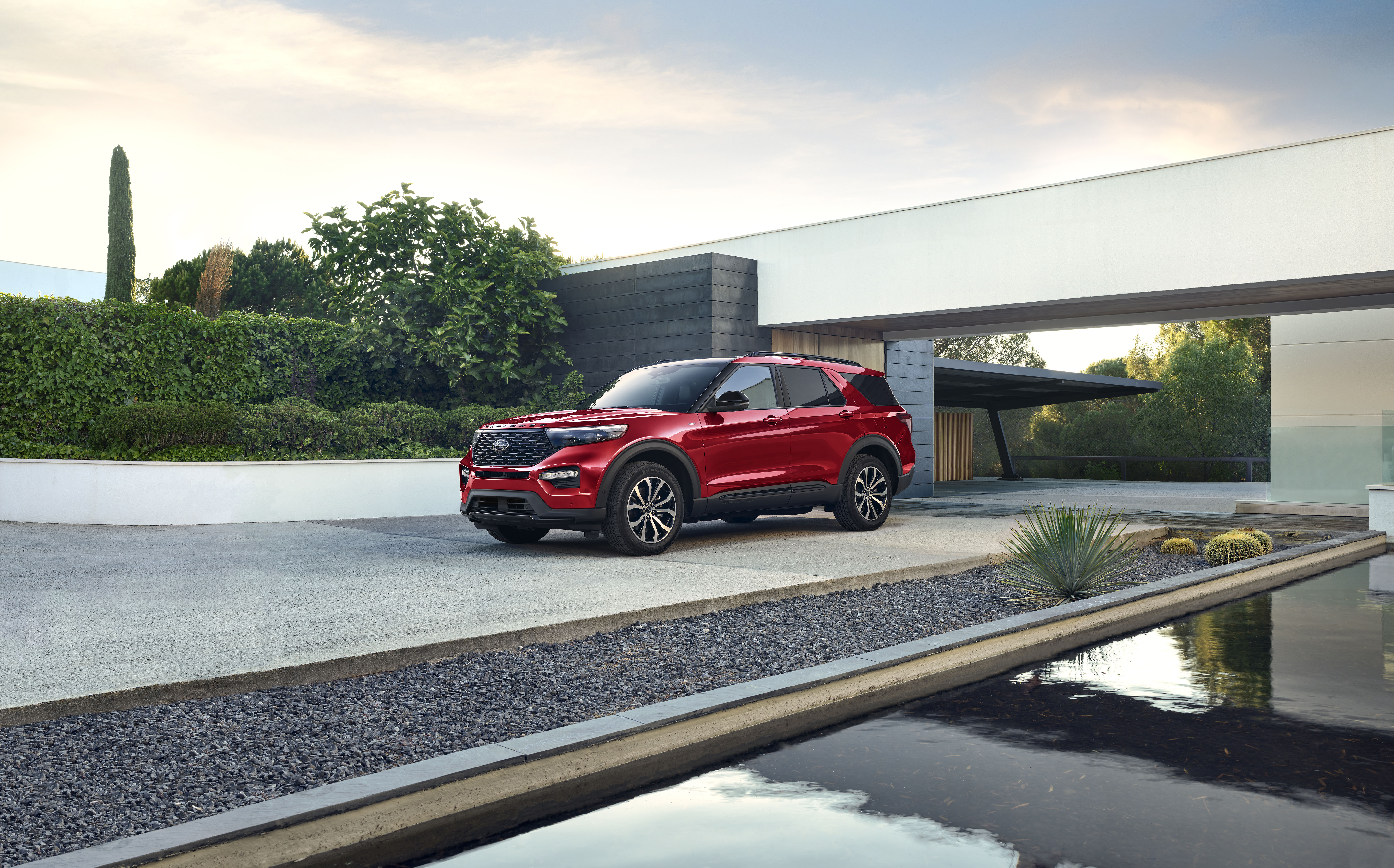 Red Ford Explorer ST-Line SUV at a modern home HD Wallpaper