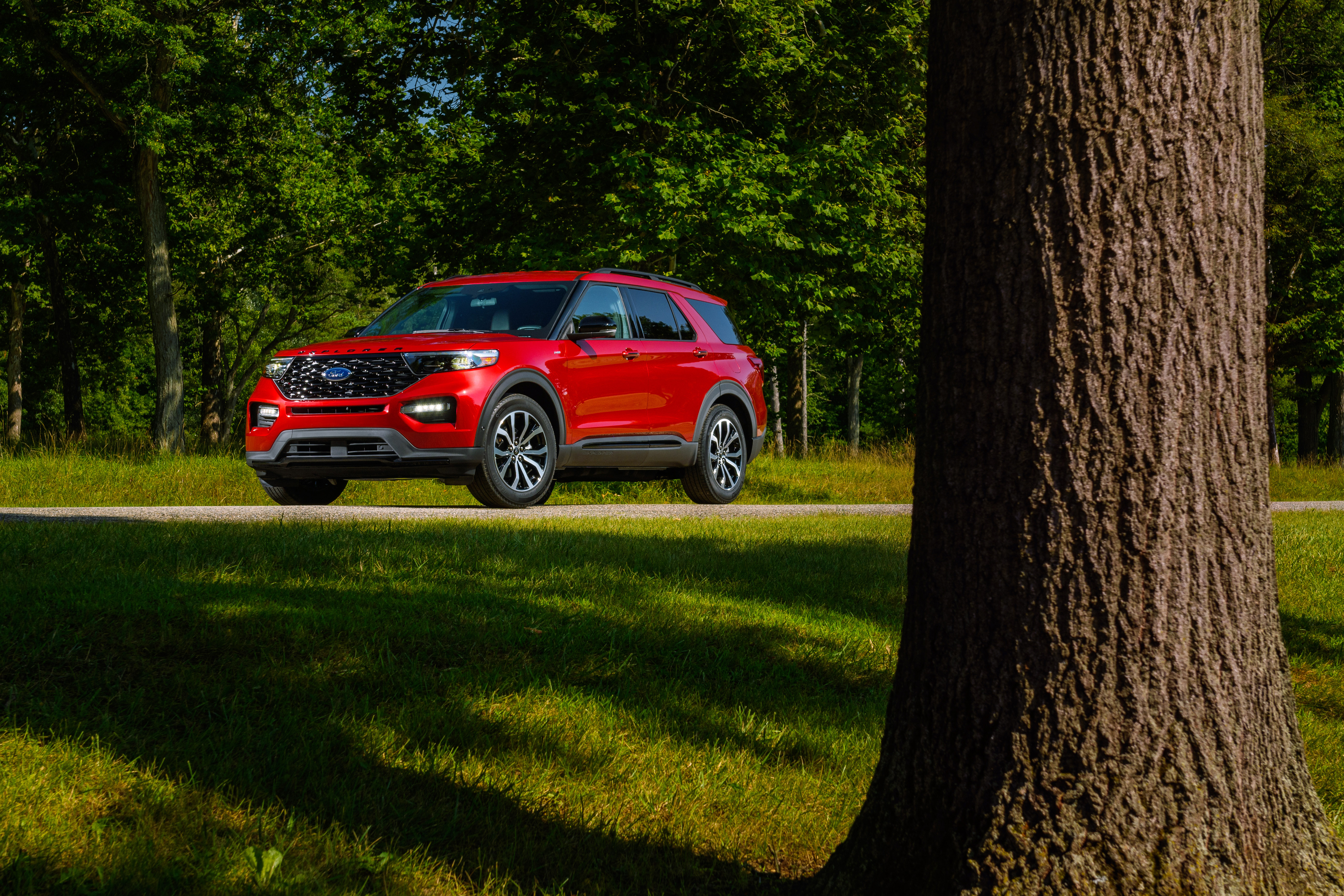 2022 Red Ford Explorer ST-Line in a park HD Wallpaper