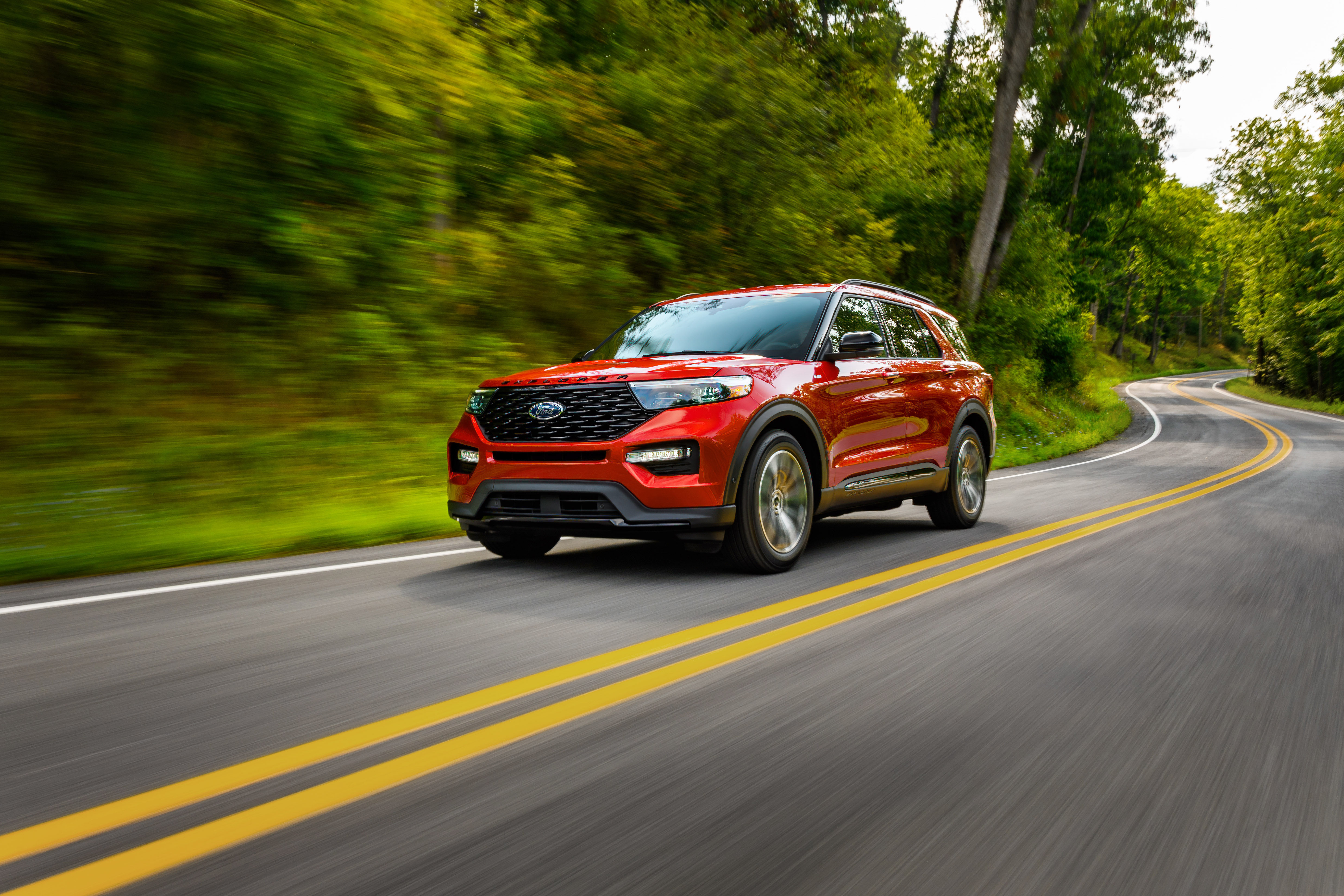 Red Ford Explorer ST-Line SUV driving on a winding road HD Wallpaper