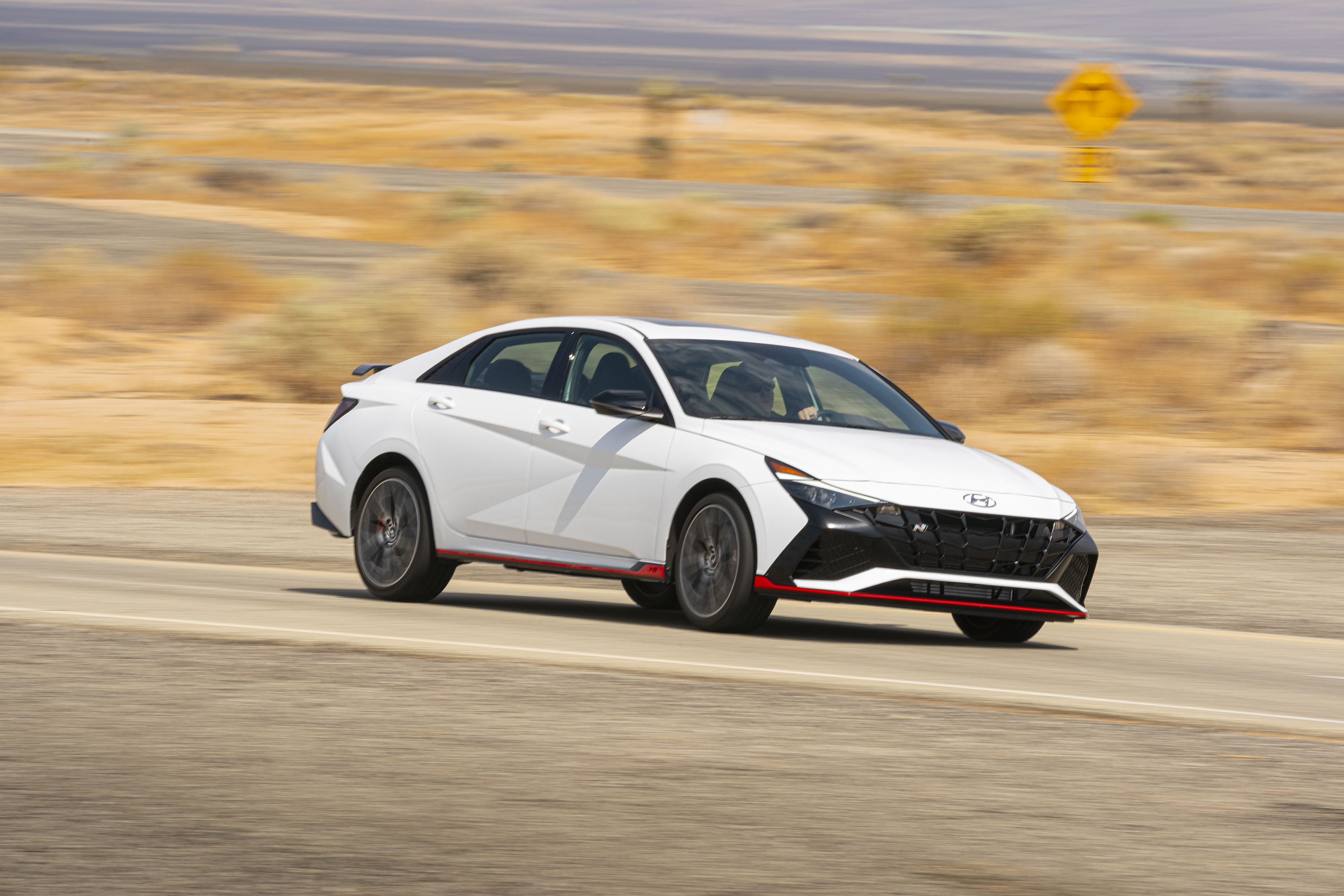 2022 Hyundai Elantra N sport car on desert road HD Wallpaper