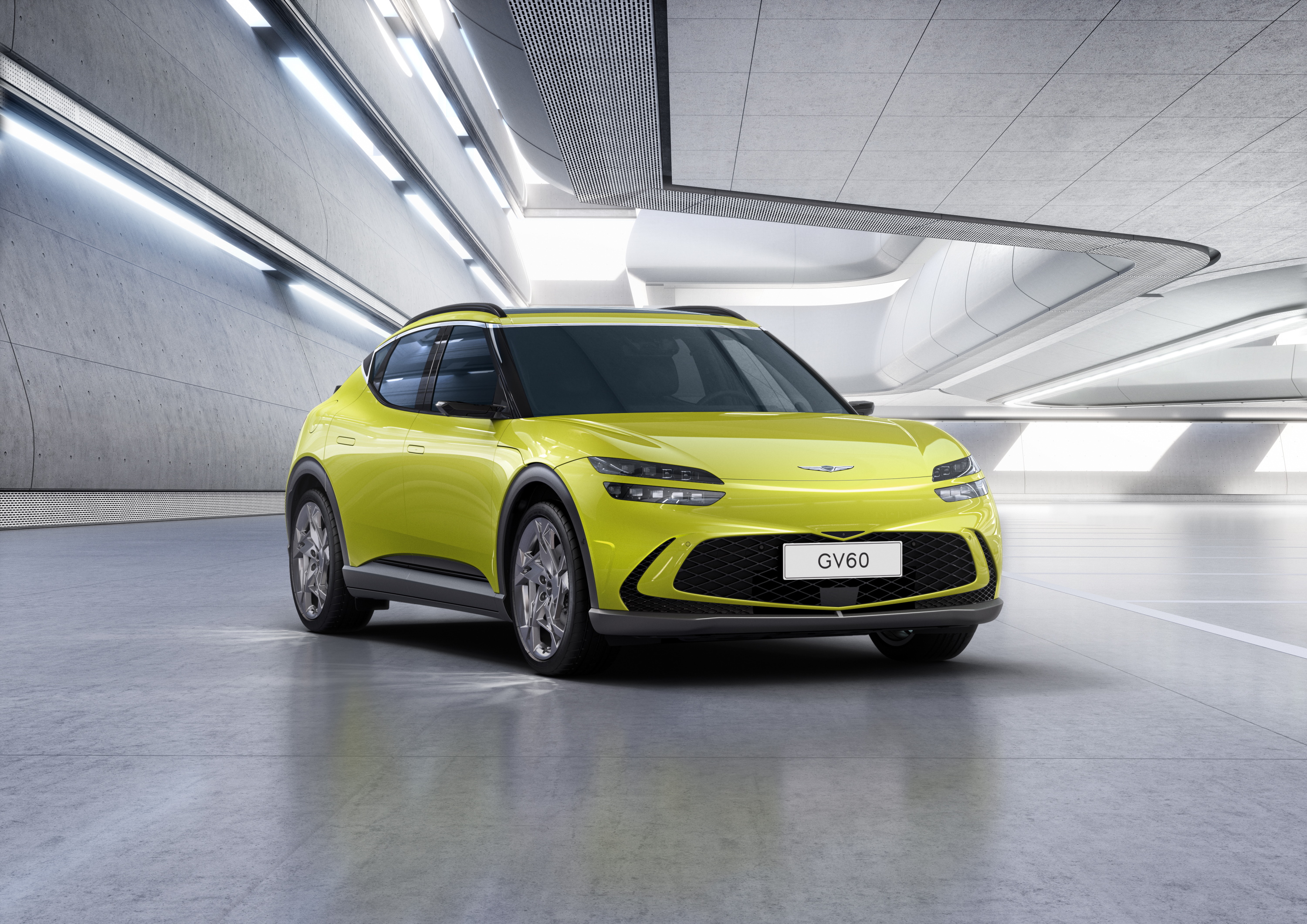 Yellow Genesis GV60 SUV in modern showroom HD Wallpaper
