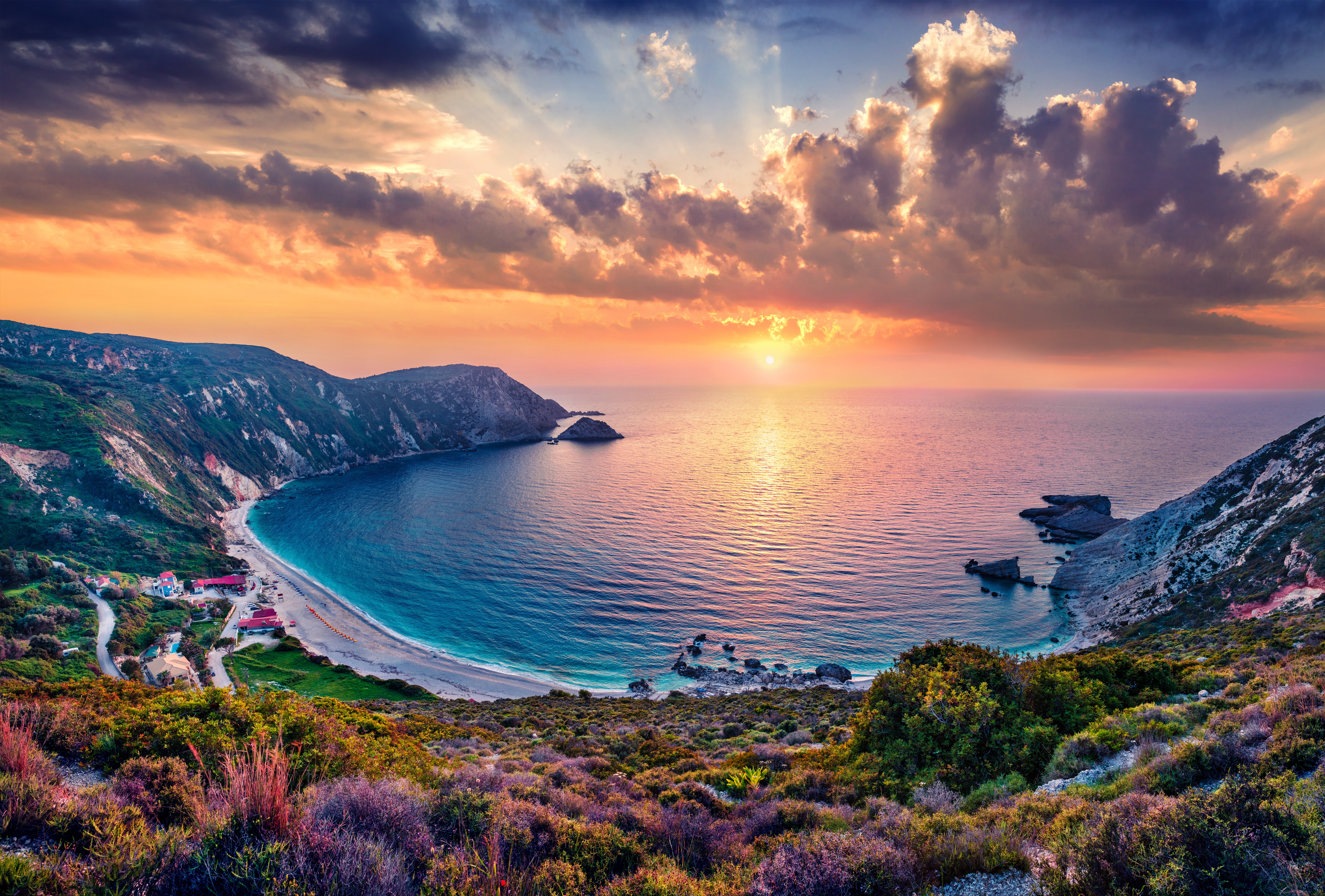 Vibrant sunset over a beautiful ocean bay and cliffs HD Wallpaper