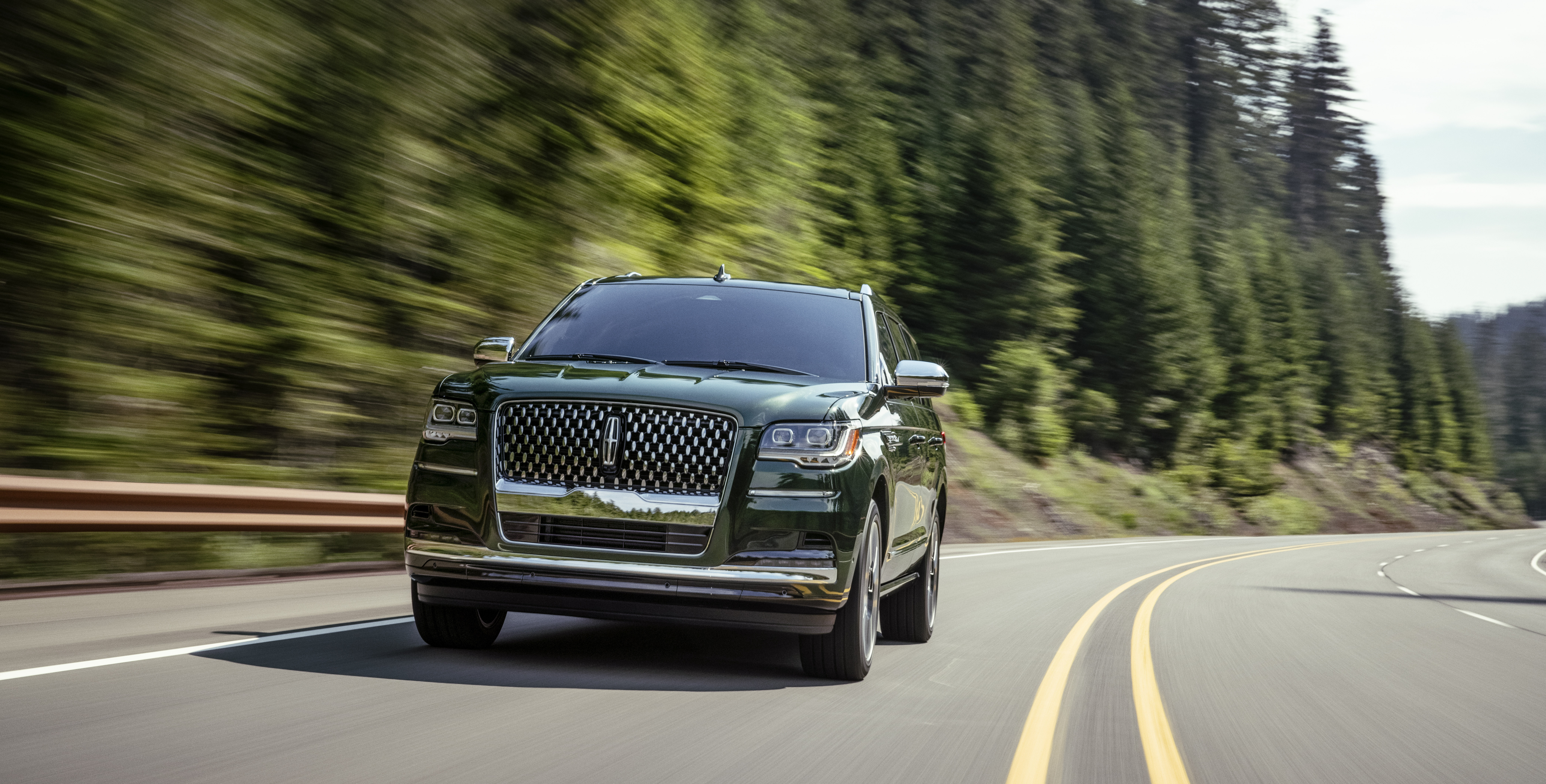 2022 Lincoln Navigator Black Label SUV on a winding forest road HD Wallpaper
