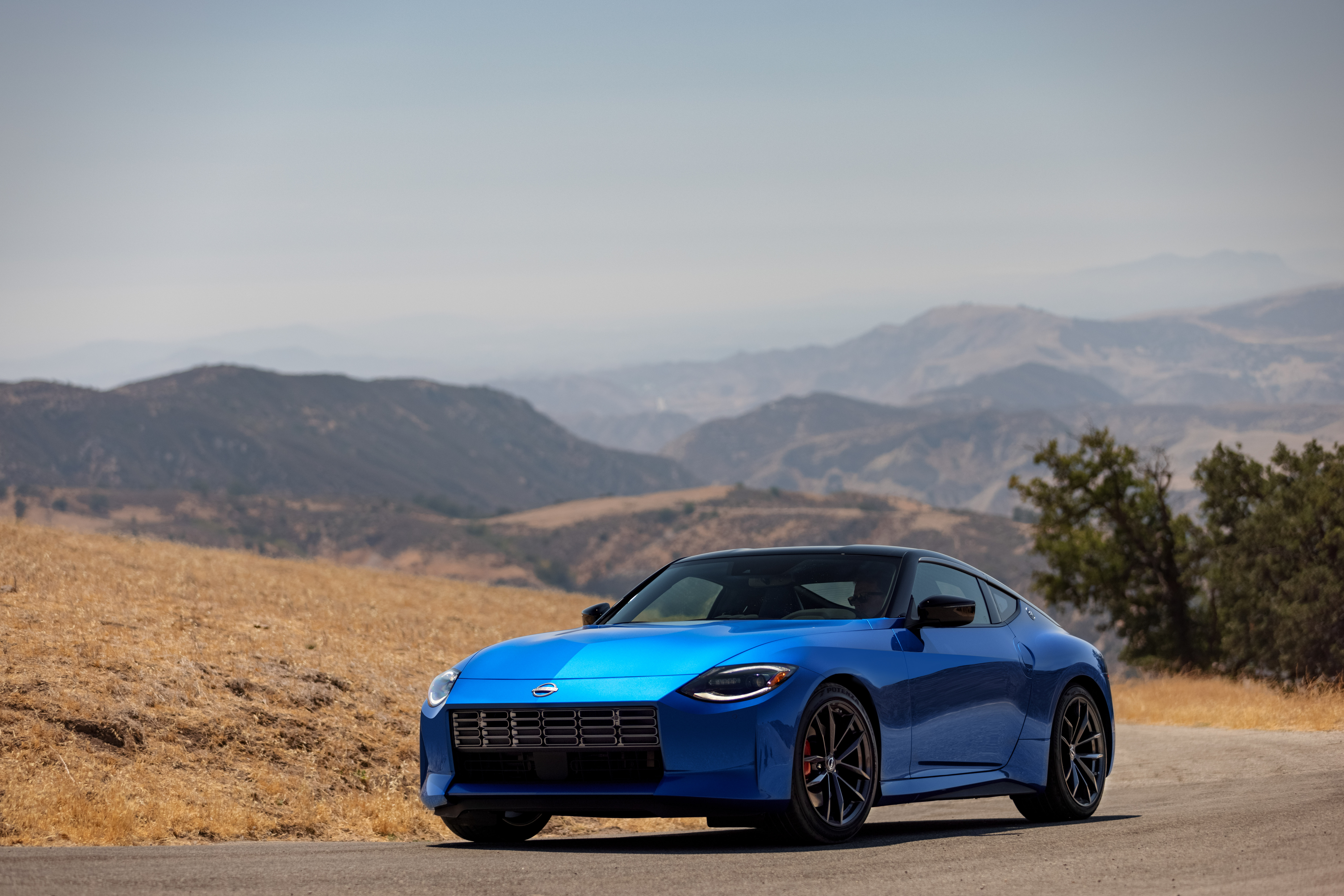 Blue Nissan Z Performance Sport Car on Mountain Road HD Wallpaper