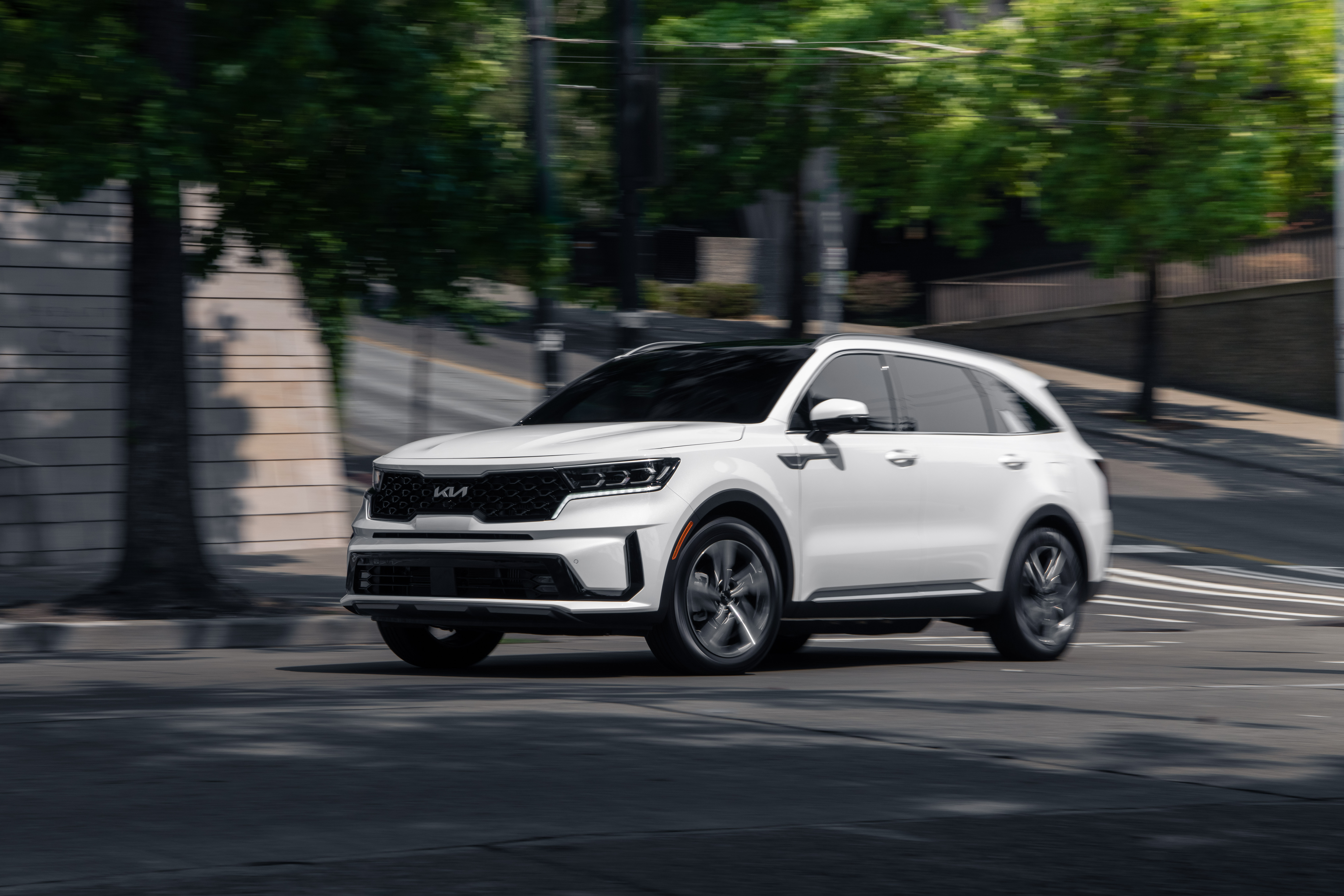 White Kia Sorento PHEV SUV driving on street HD Wallpaper