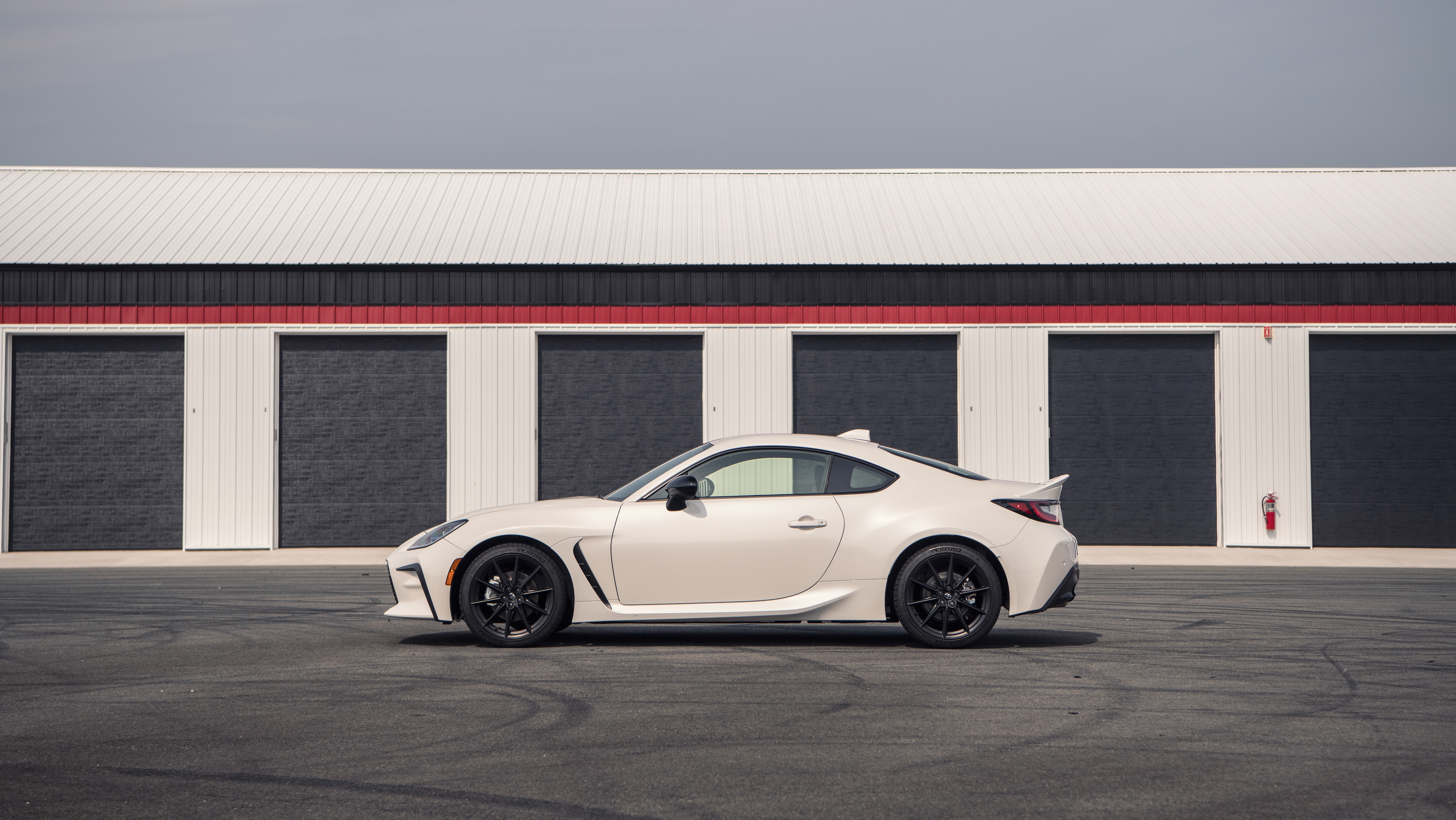 Toyota GR 86 sport car parked in front of garages HD Wallpaper