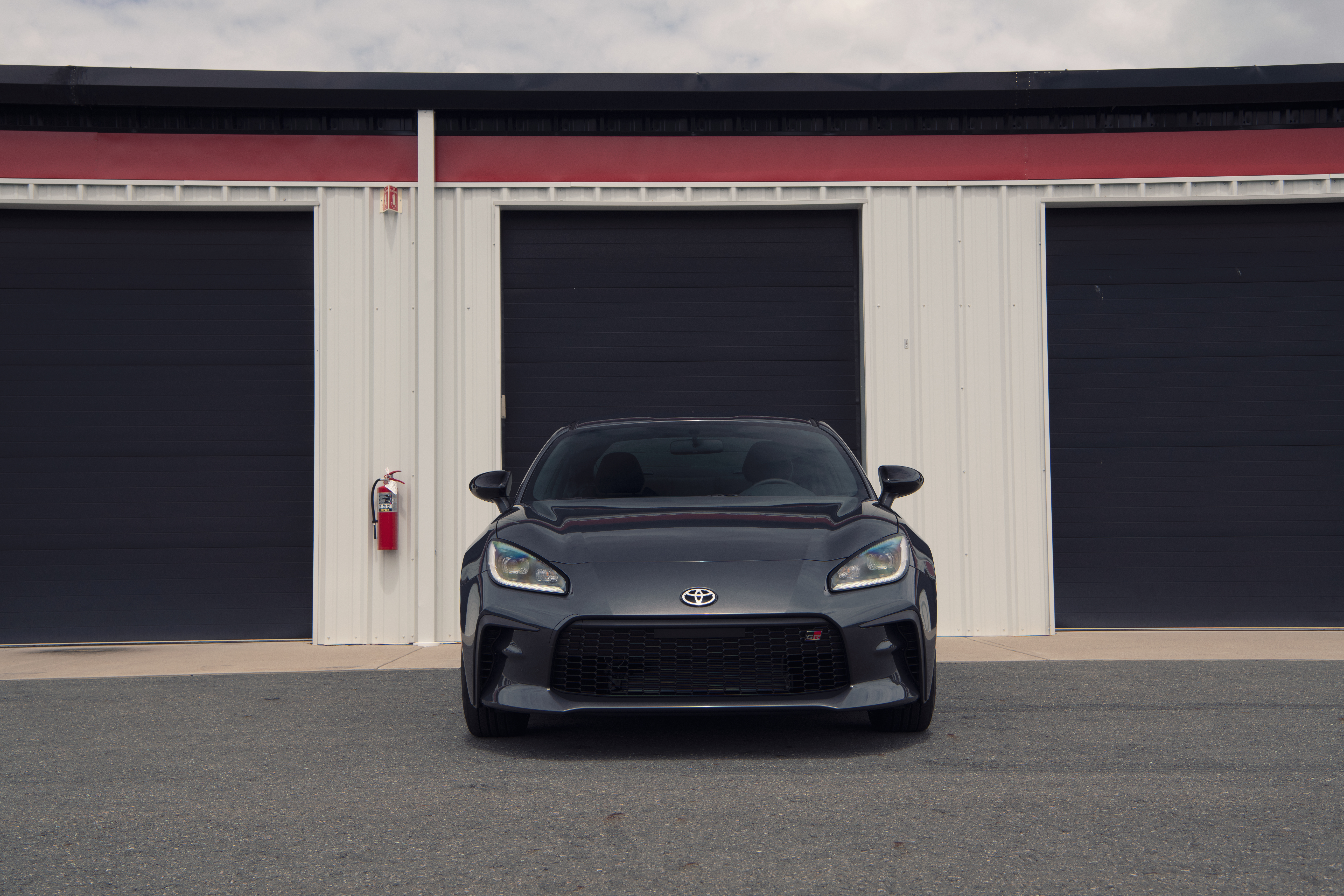 Toyota GR 86 sport car in front of garages HD Wallpaper