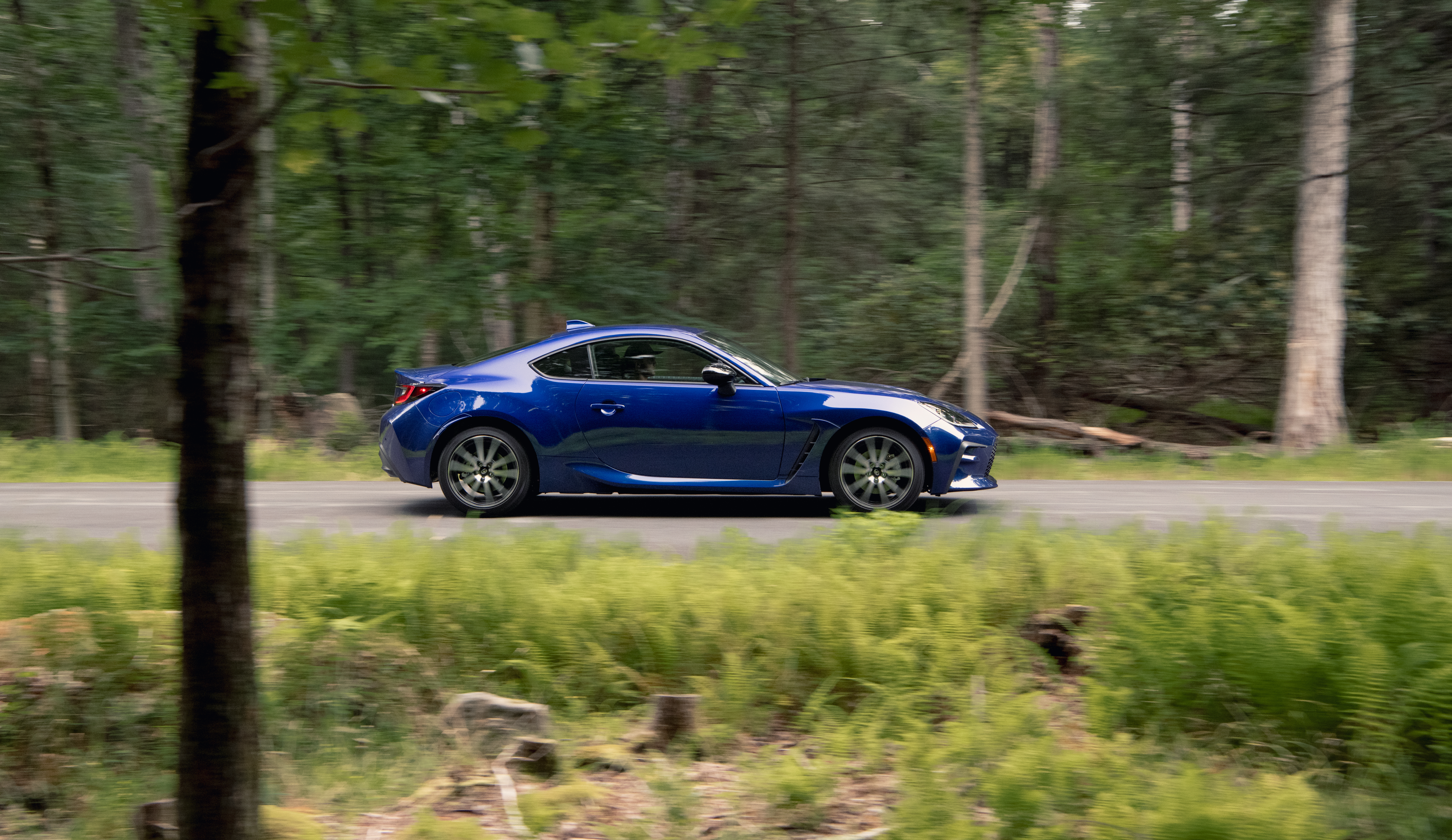 Blue Toyota GR 86 Sport Car Driving in Forest HD Wallpaper