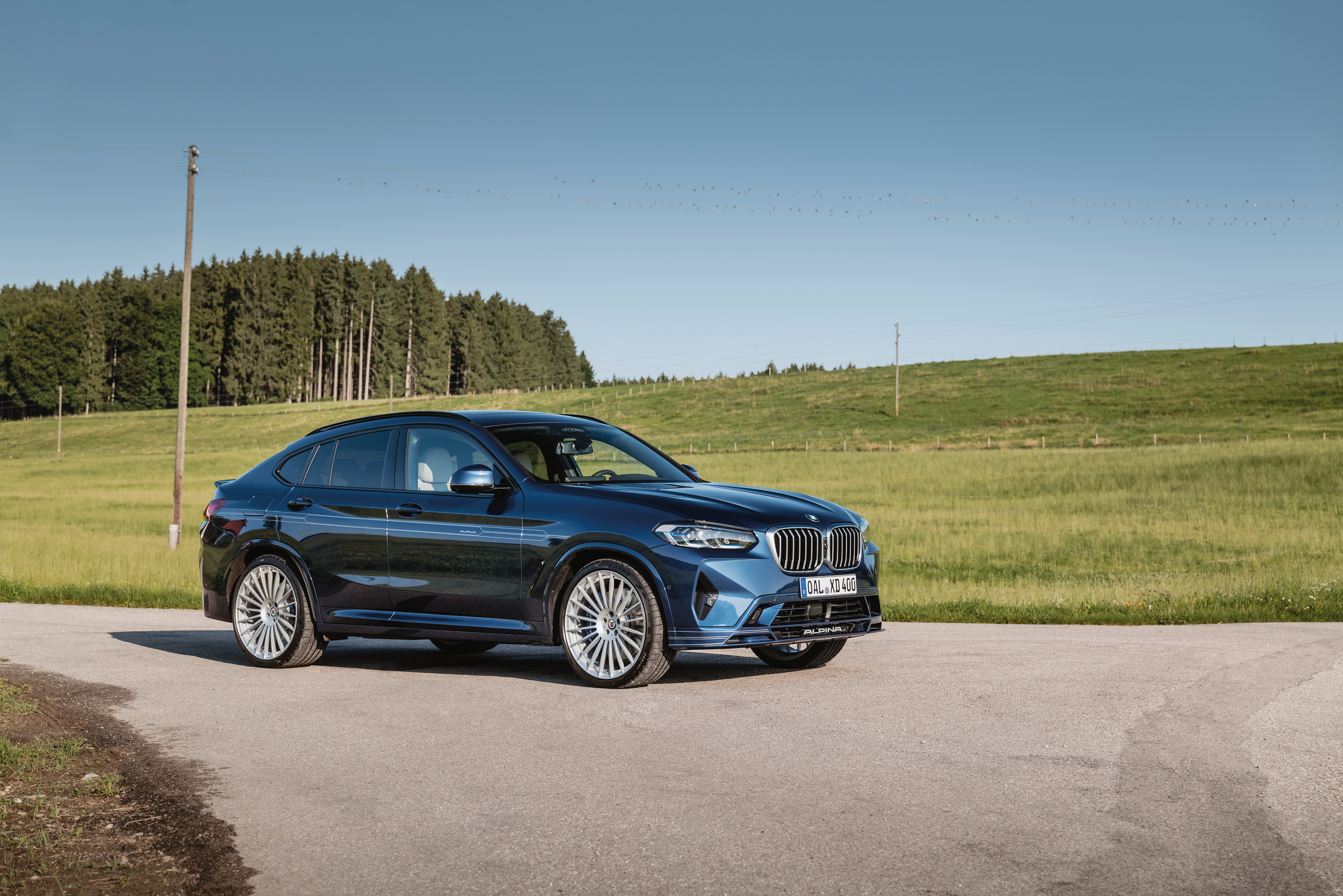 Blue BMW Alpina XD4 SUV on a rural road HD Wallpaper