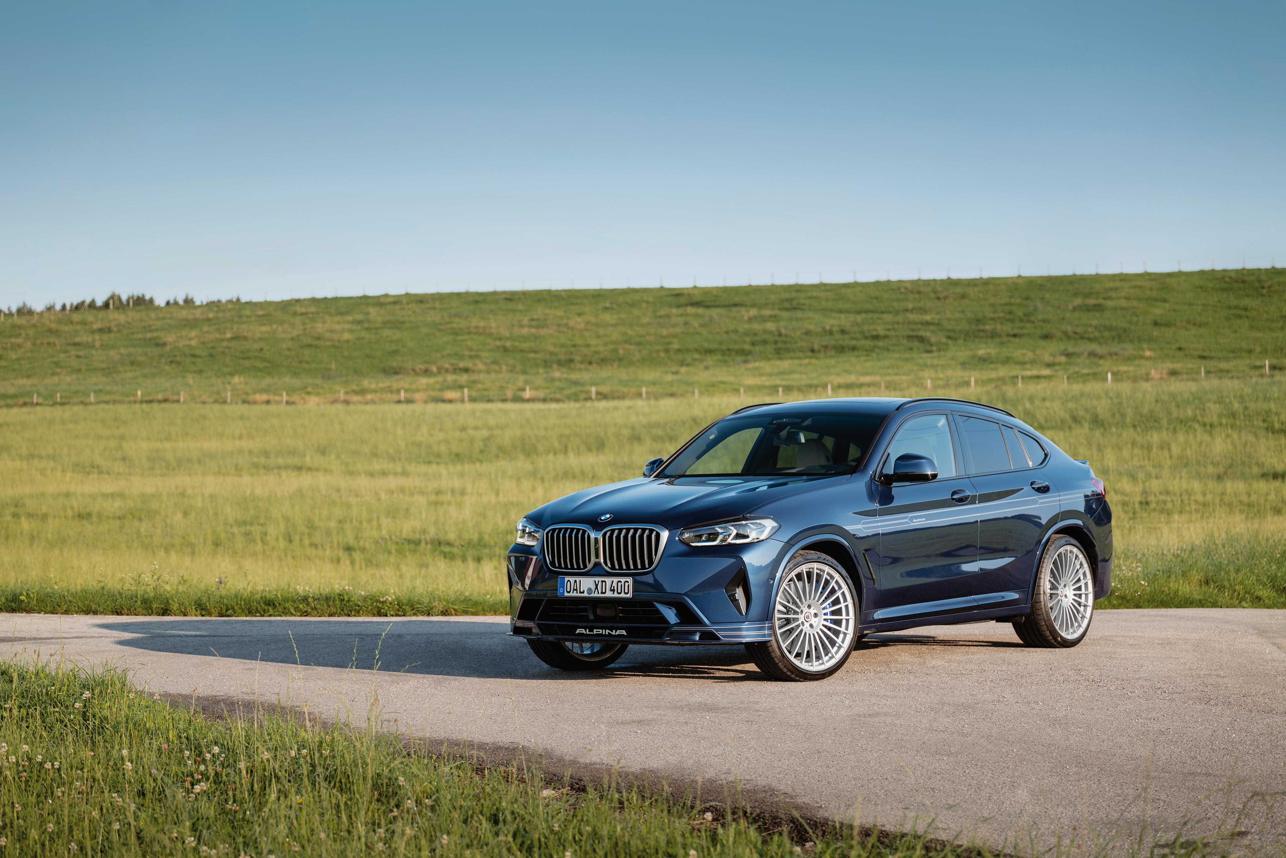 Blue BMW Alpina XD4 SUV in a rural landscape HD Wallpaper