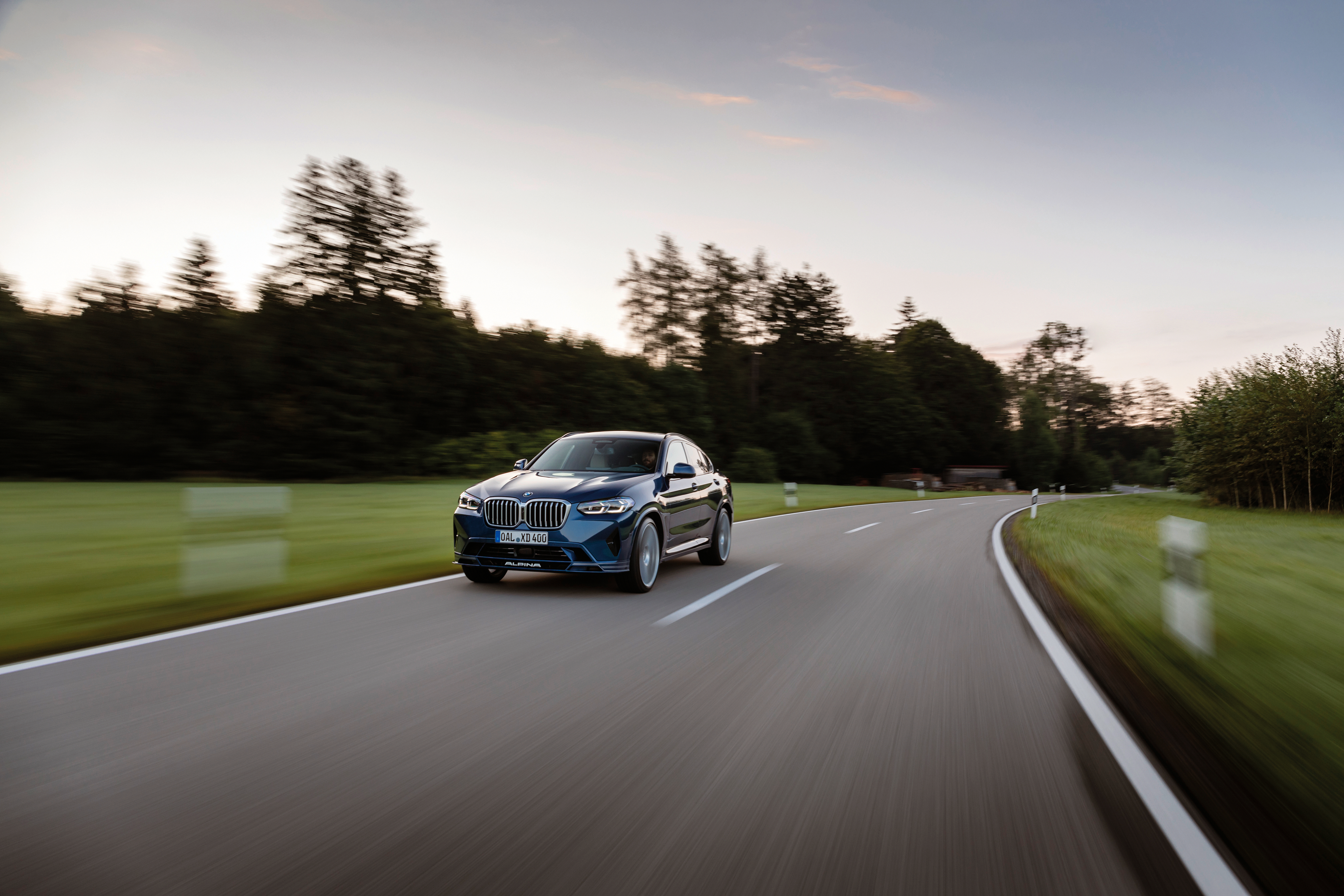 BMW Alpina XD4 SUV driving on a winding road HD Wallpaper