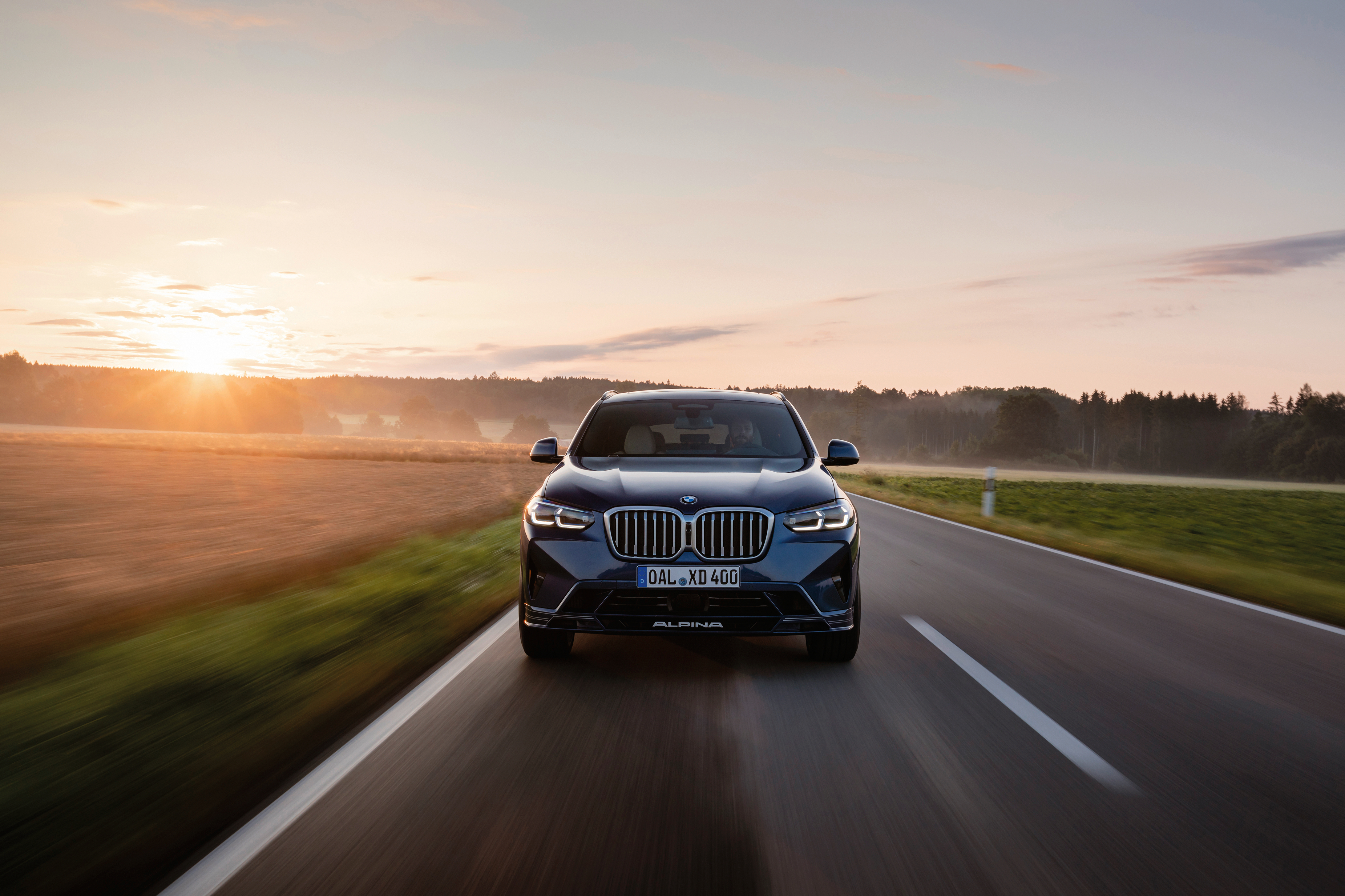 BMW Alpina XD4 SUV driving into the sunrise HD Wallpaper