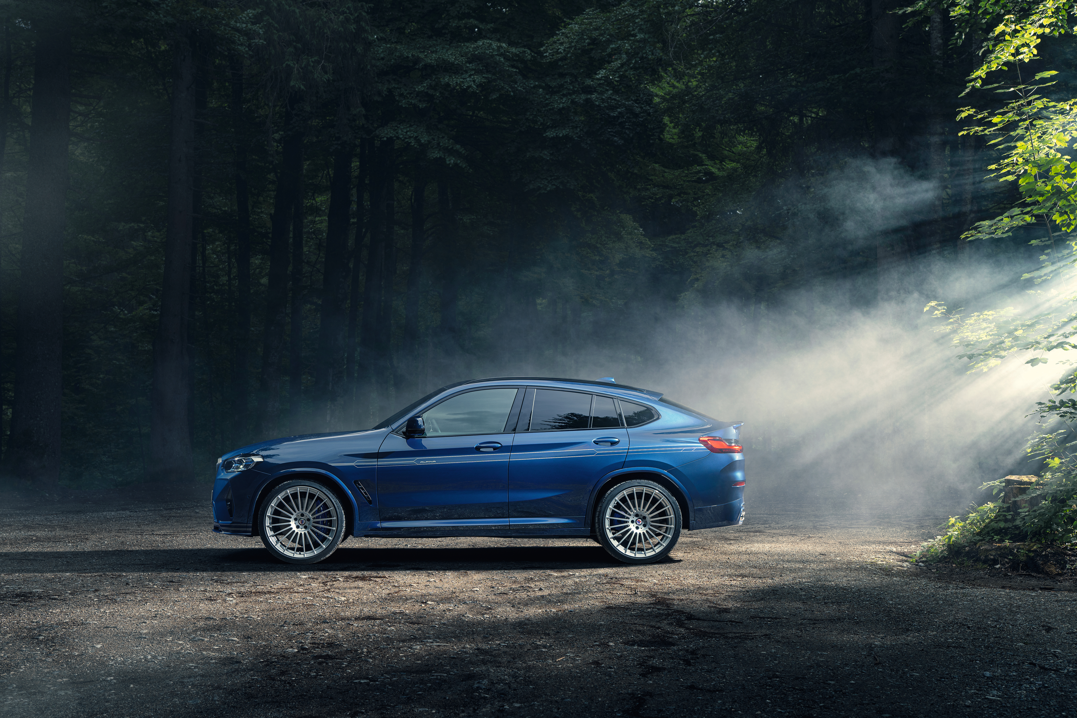 BMW Alpina XD4 SUV in misty forest with sunbeams HD Wallpaper