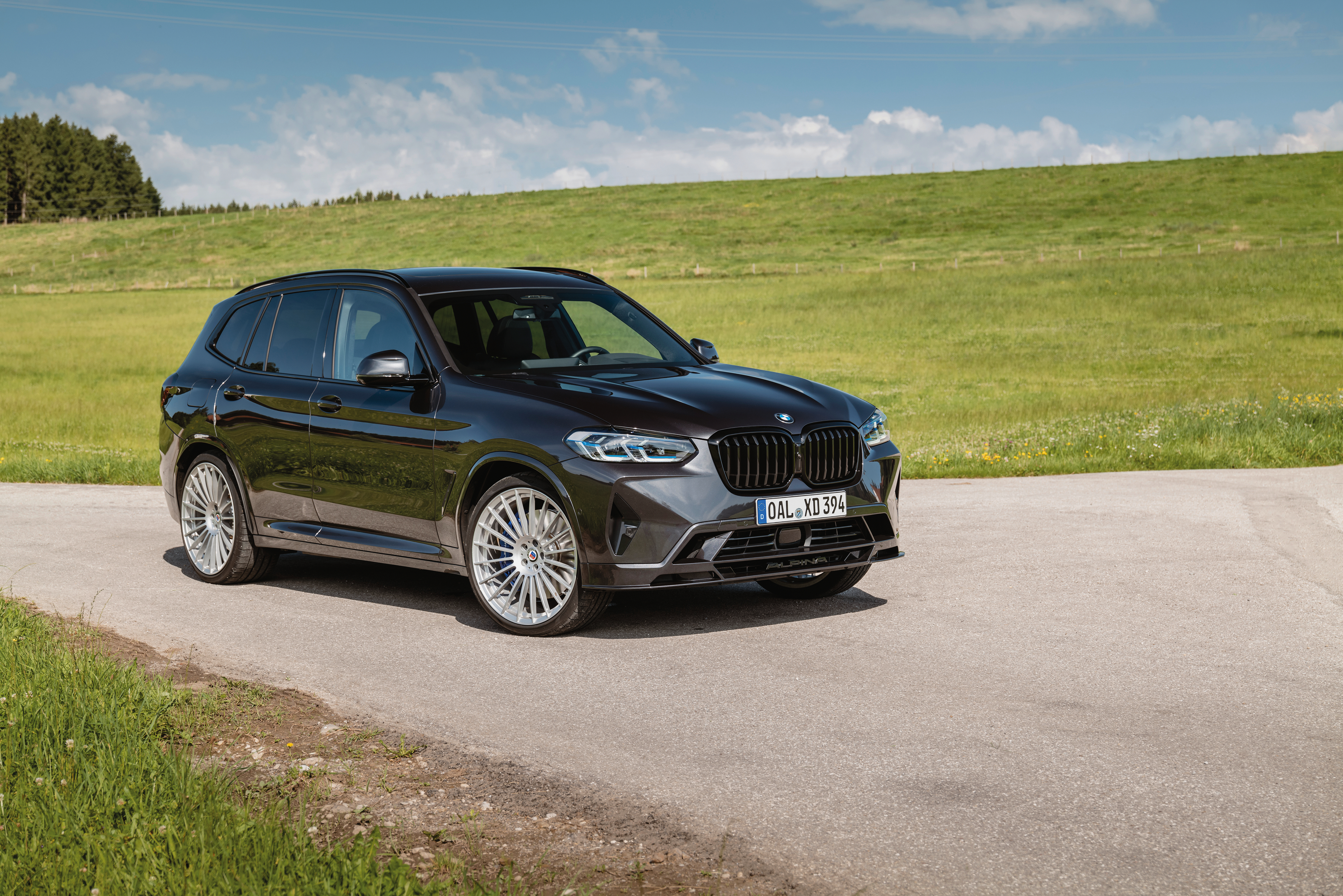 Dark BMW Alpina XD3 SUV on a country road HD Wallpaper