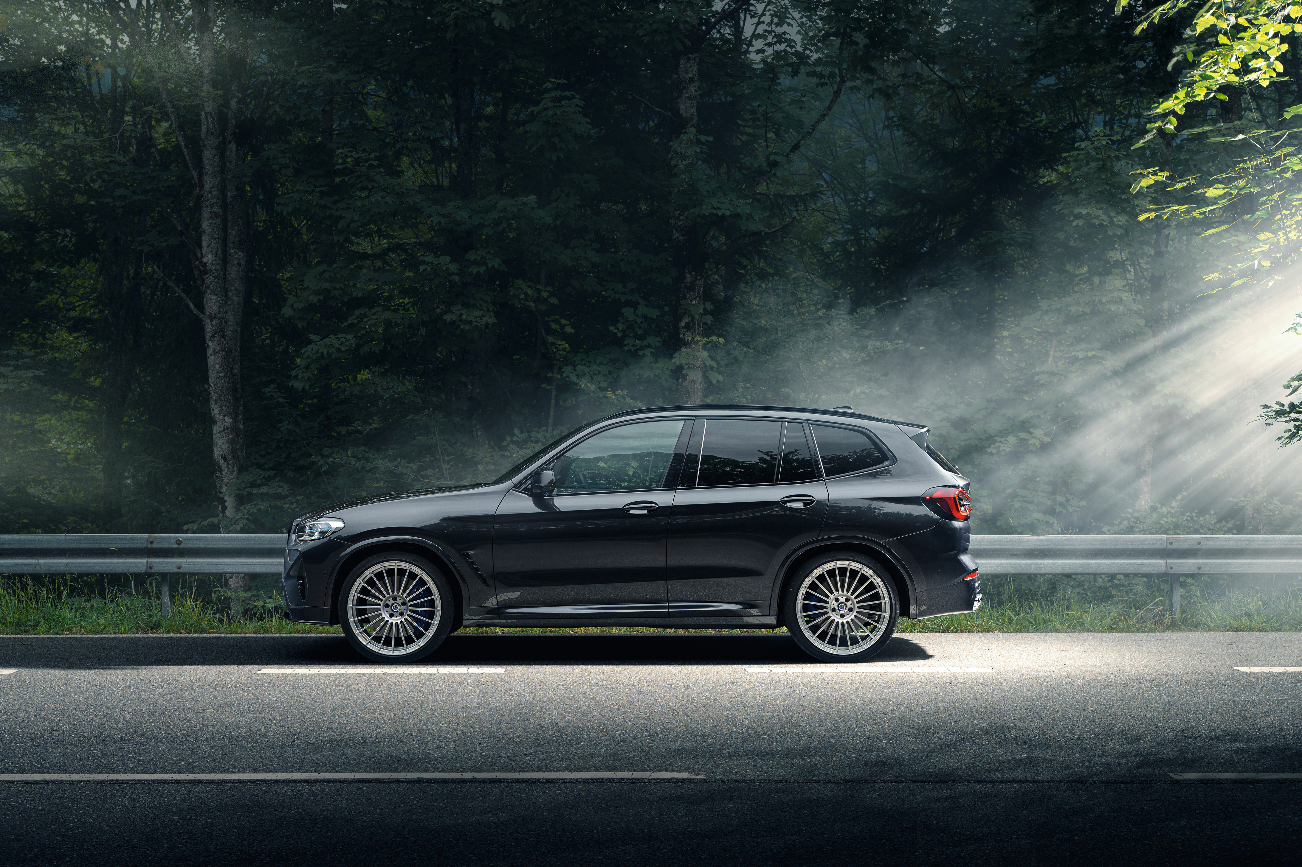 BMW Alpina XD3 SUV in misty forest road HD Wallpaper