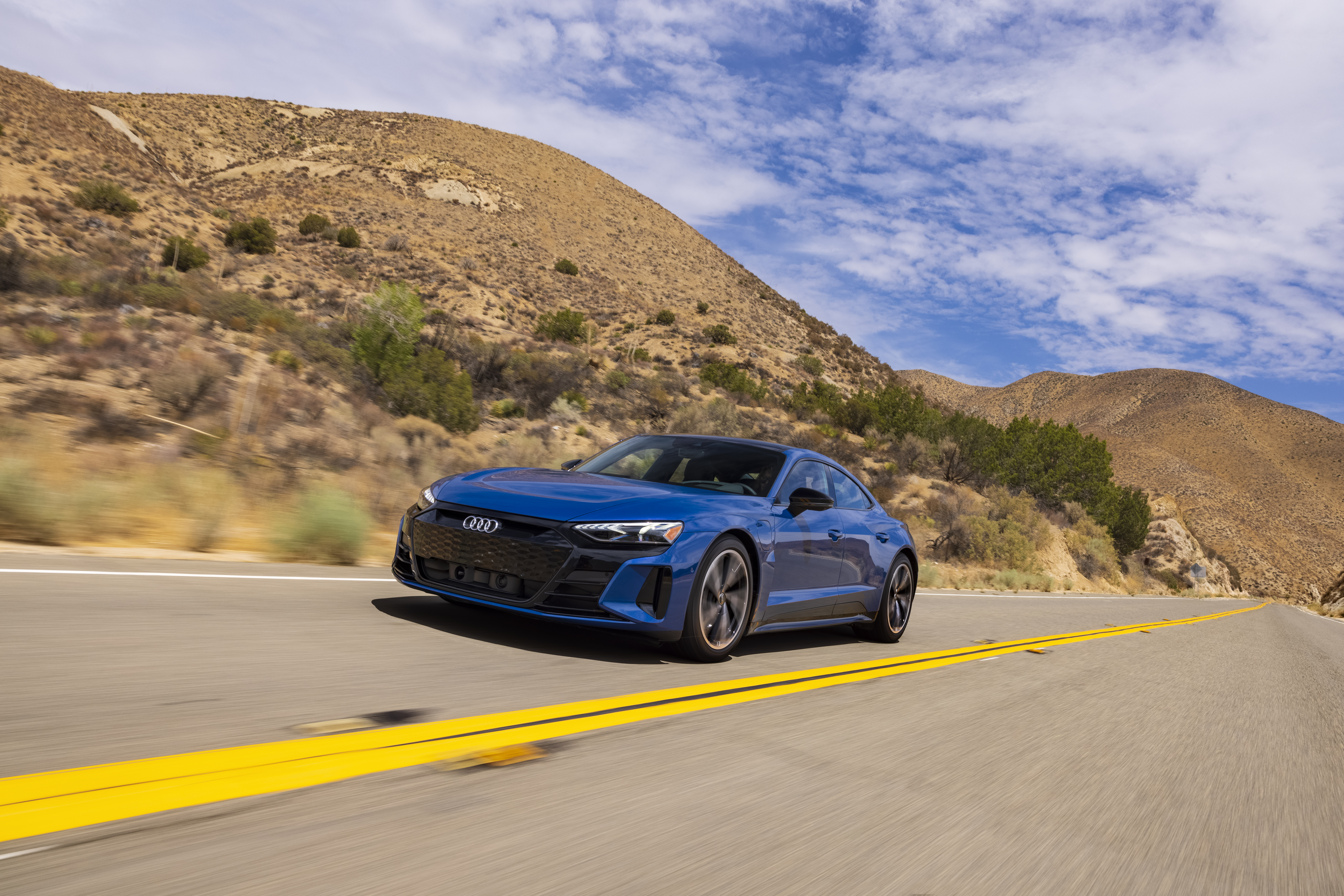 Blue Audi e-tron GT Quattro electric car on desert road HD Wallpaper