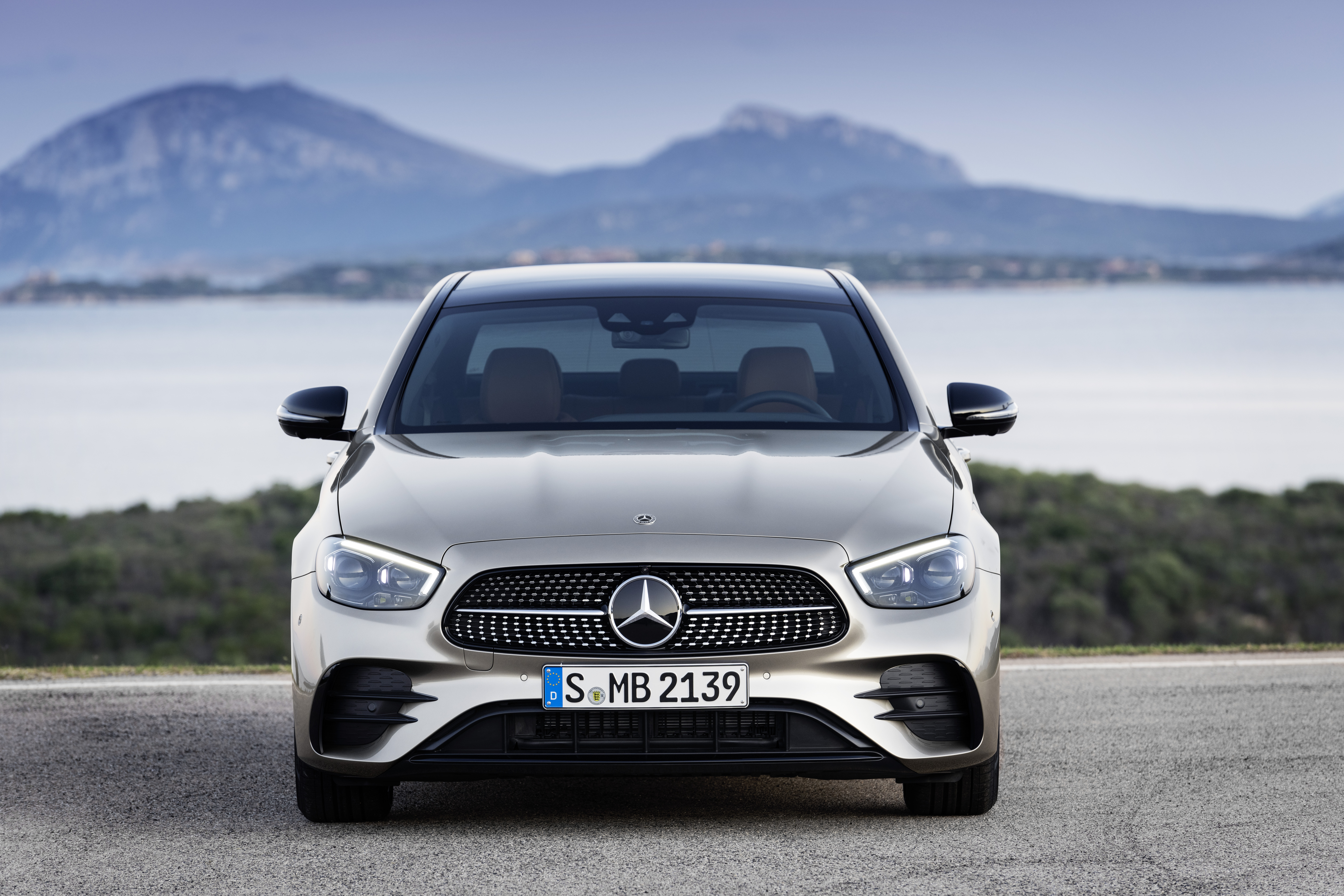 Silver Mercedes-Benz E 450 sedan by the sea and mountains HD Wallpaper