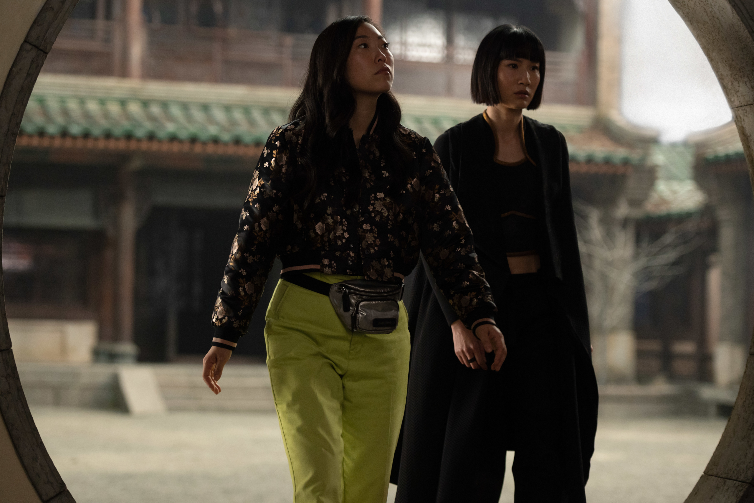 Awkwafina and Menger Zhang in a temple courtyard HD Wallpaper