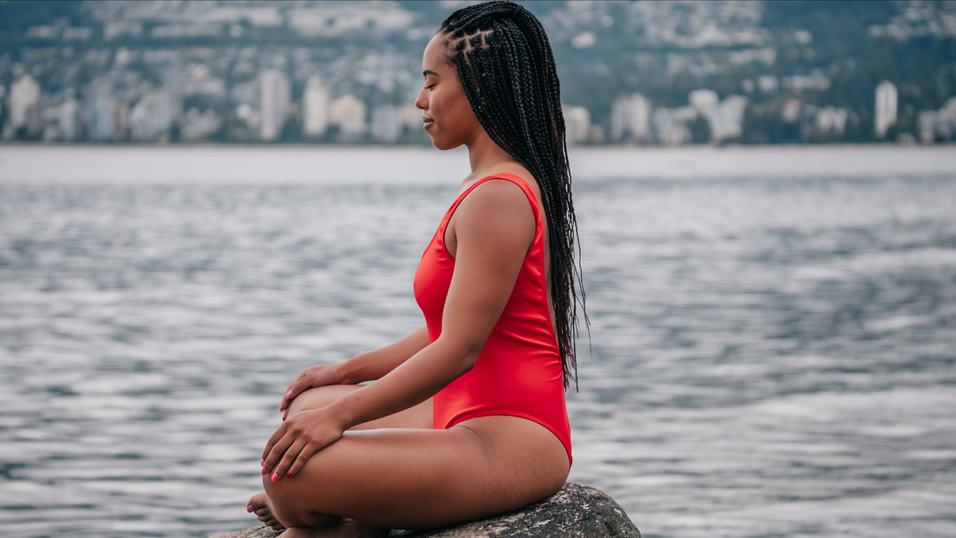 Peaceful woman in red swimsuit by the water HD Wallpaper