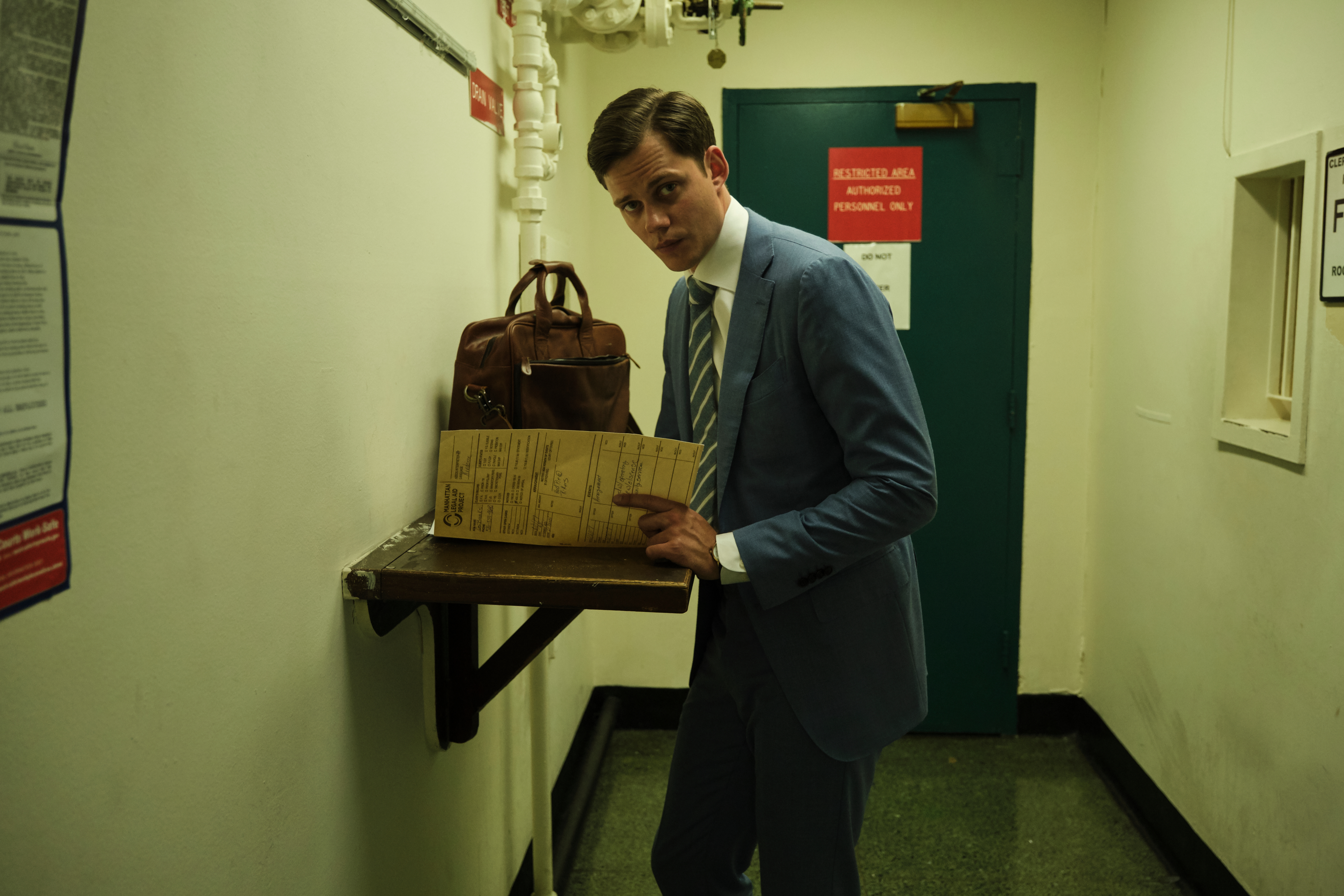 Bill Skarsgård looking at papers in Naked Singularity HD Wallpaper