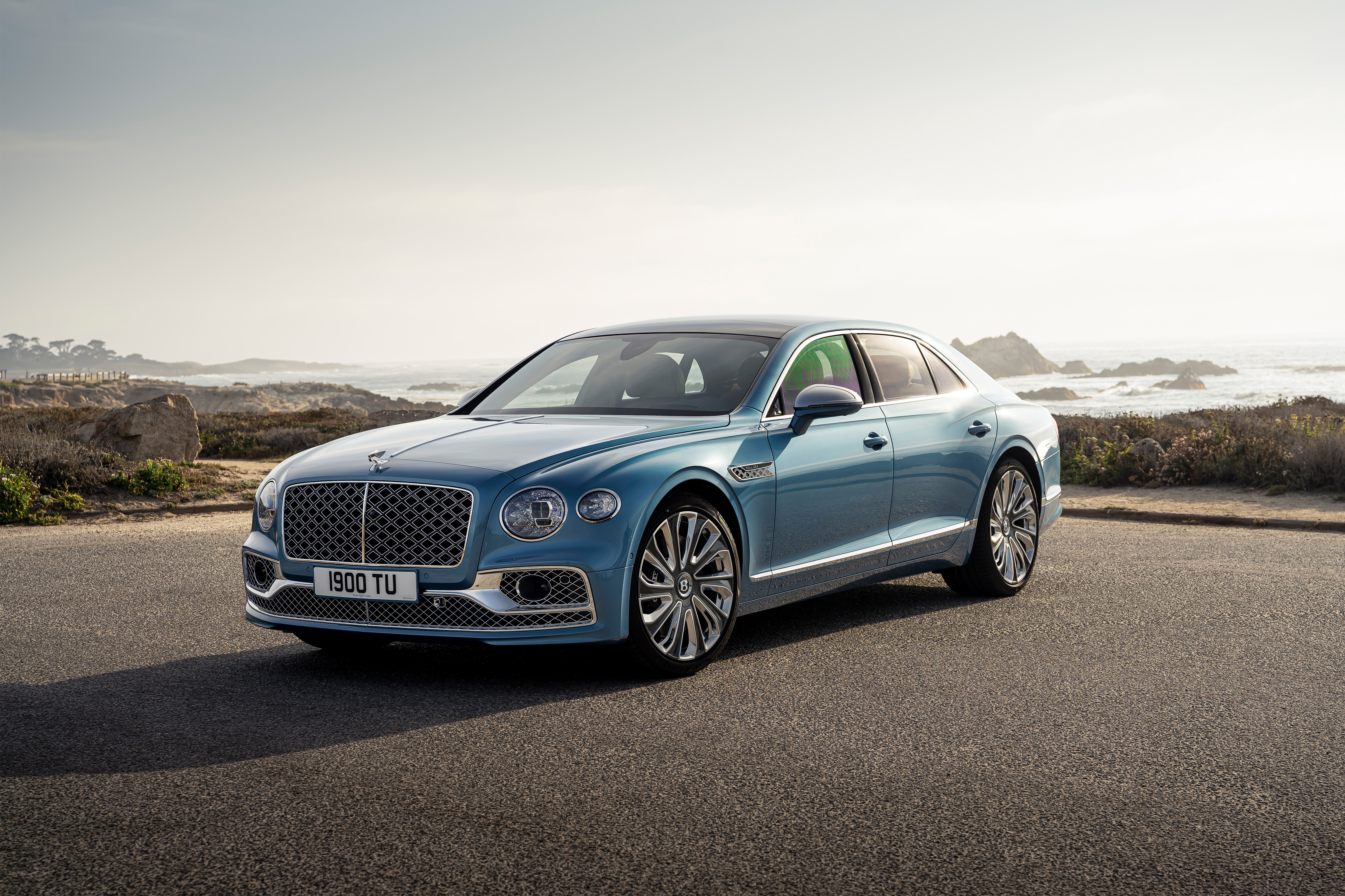 Bentley Flying Spur Mulliner on a scenic coastal road HD Wallpaper