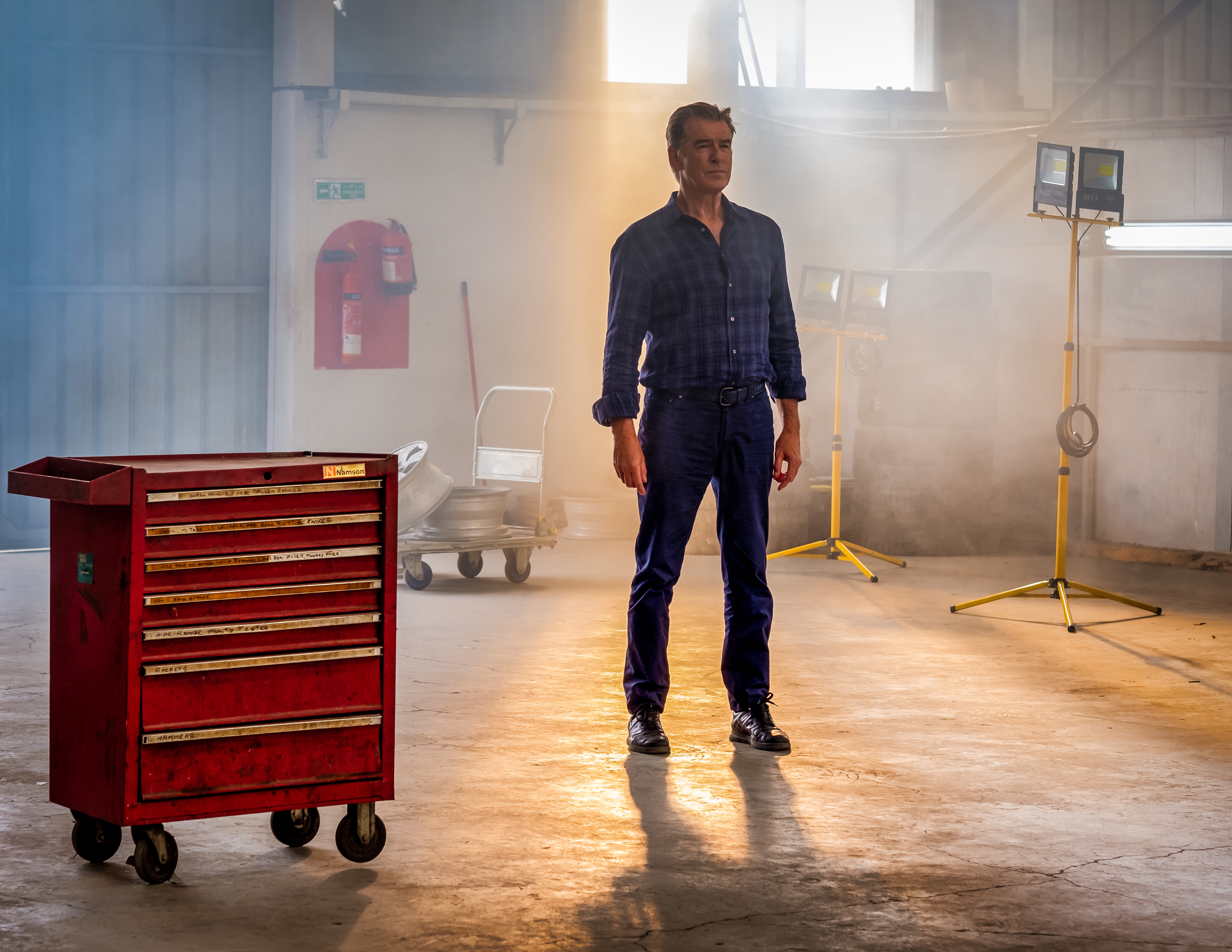 Pierce Brosnan in The Misfits in a hazy workshop HD Wallpaper