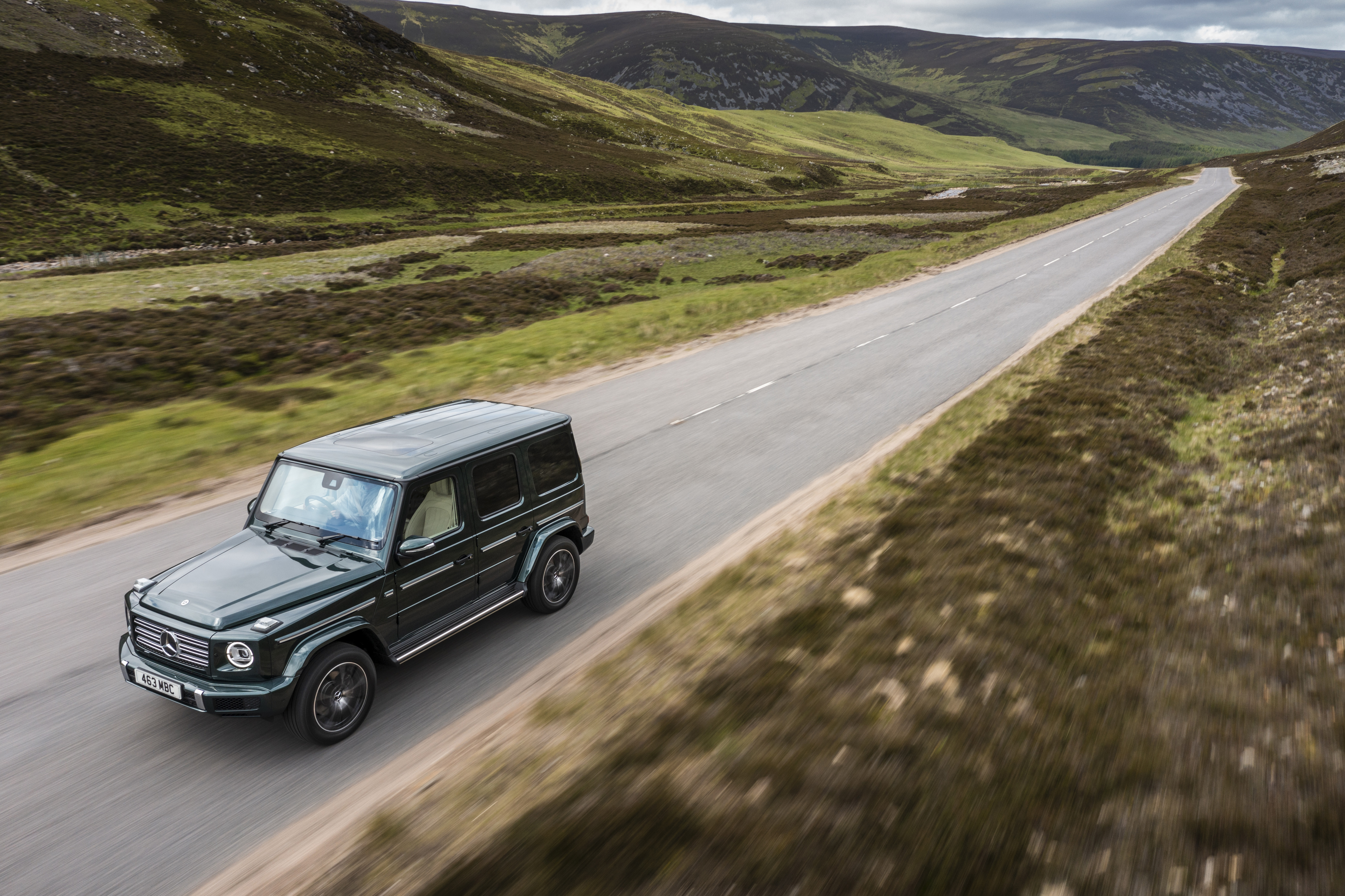 Mercedes-Benz G 400 d SUV driving on a scenic road HD Wallpaper