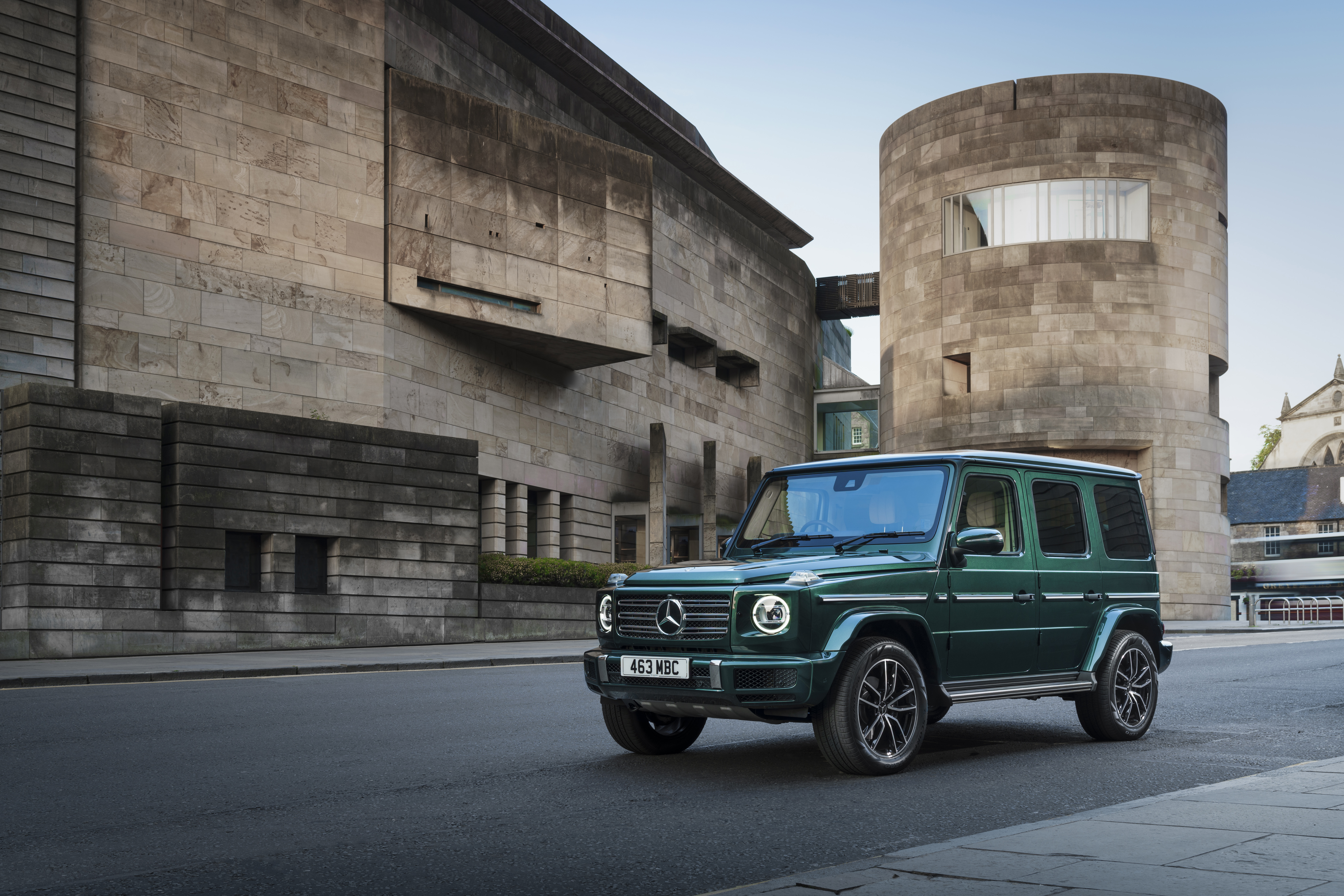 Green Mercedes-Benz G 400 d SUV by modern stone building HD Wallpaper